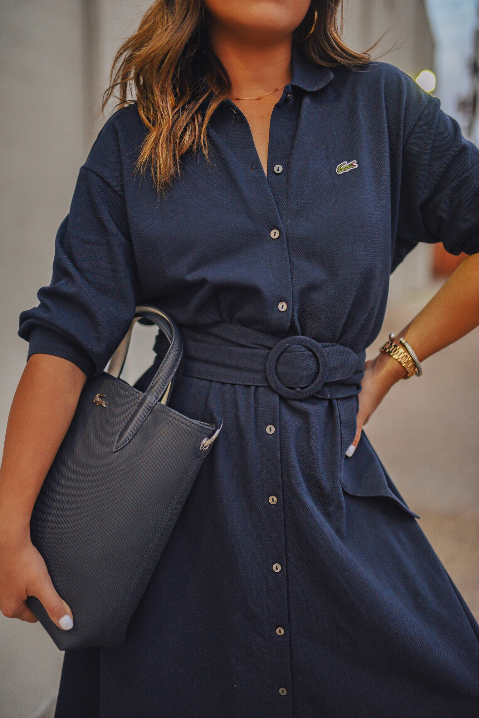 Carolina Hellal of Chic Talk wearing a Lacoste shirtdress, white sneakers and structured bag