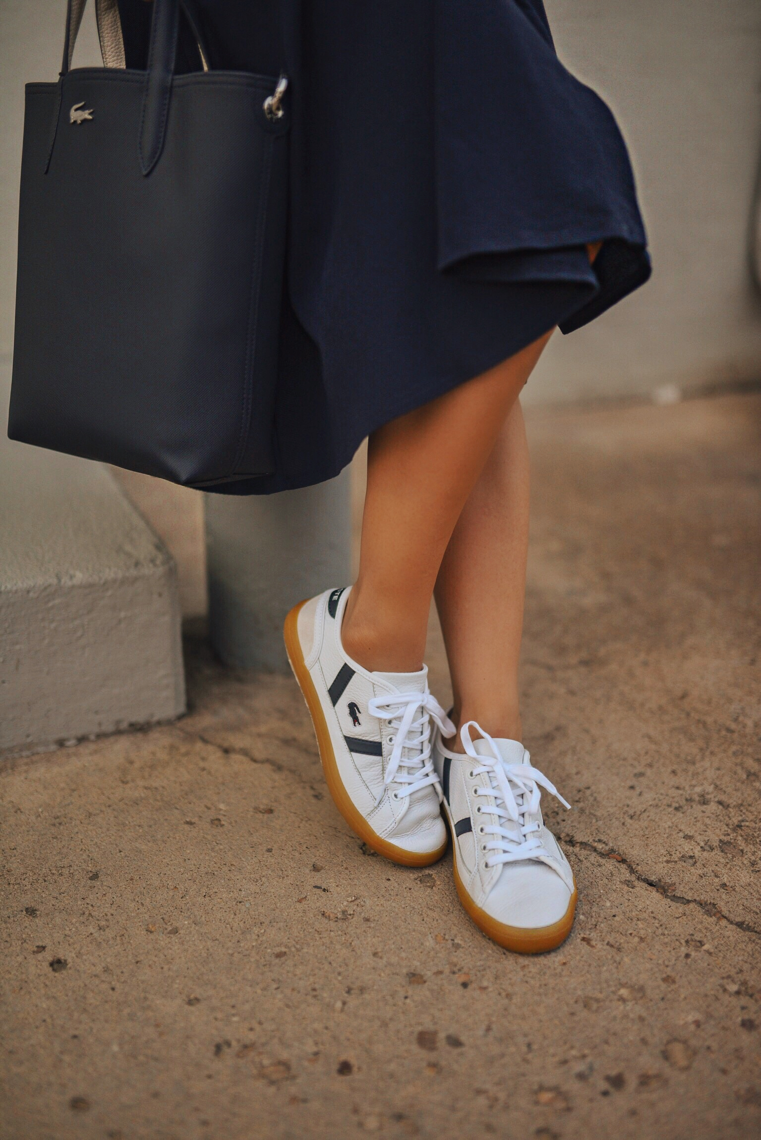 Carolina Hellal of Chic Talk wearing a Lacoste shirtdress, white sneakers and structured bag