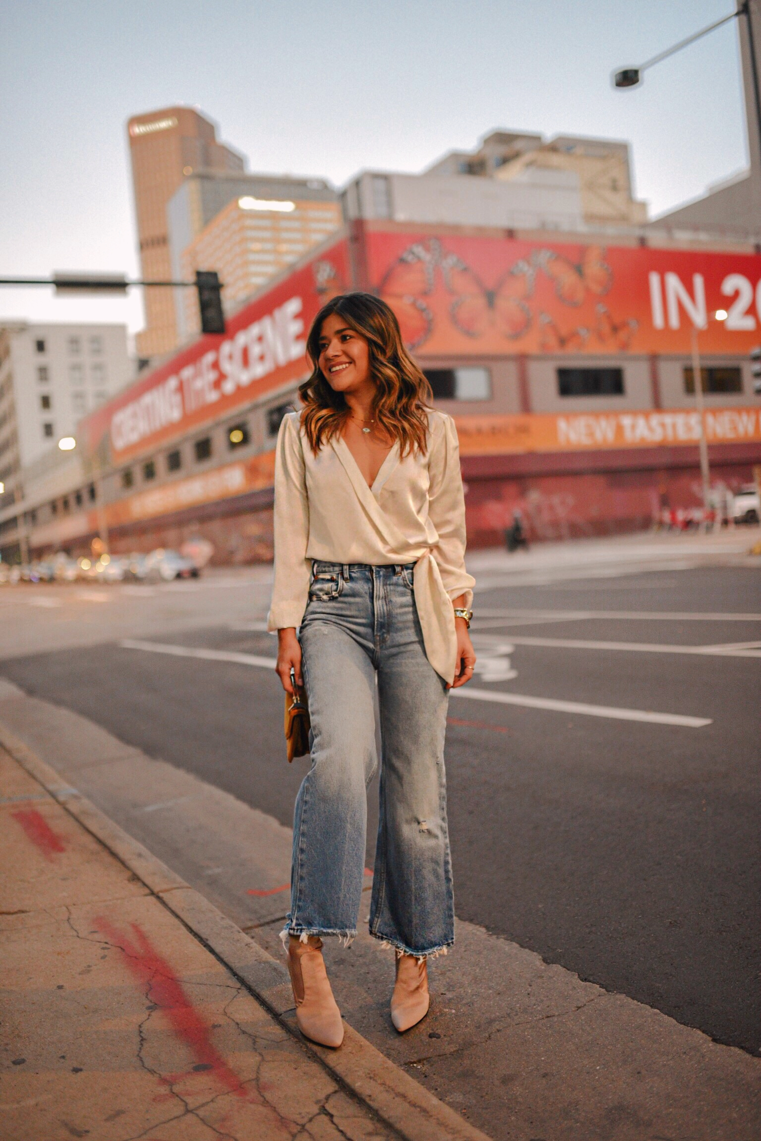 Carolina Hellal of Chic Talk wearing a silk wrap top and wide leg jeans from Abercrombie, M2Malletier bag and nude ankle boots.