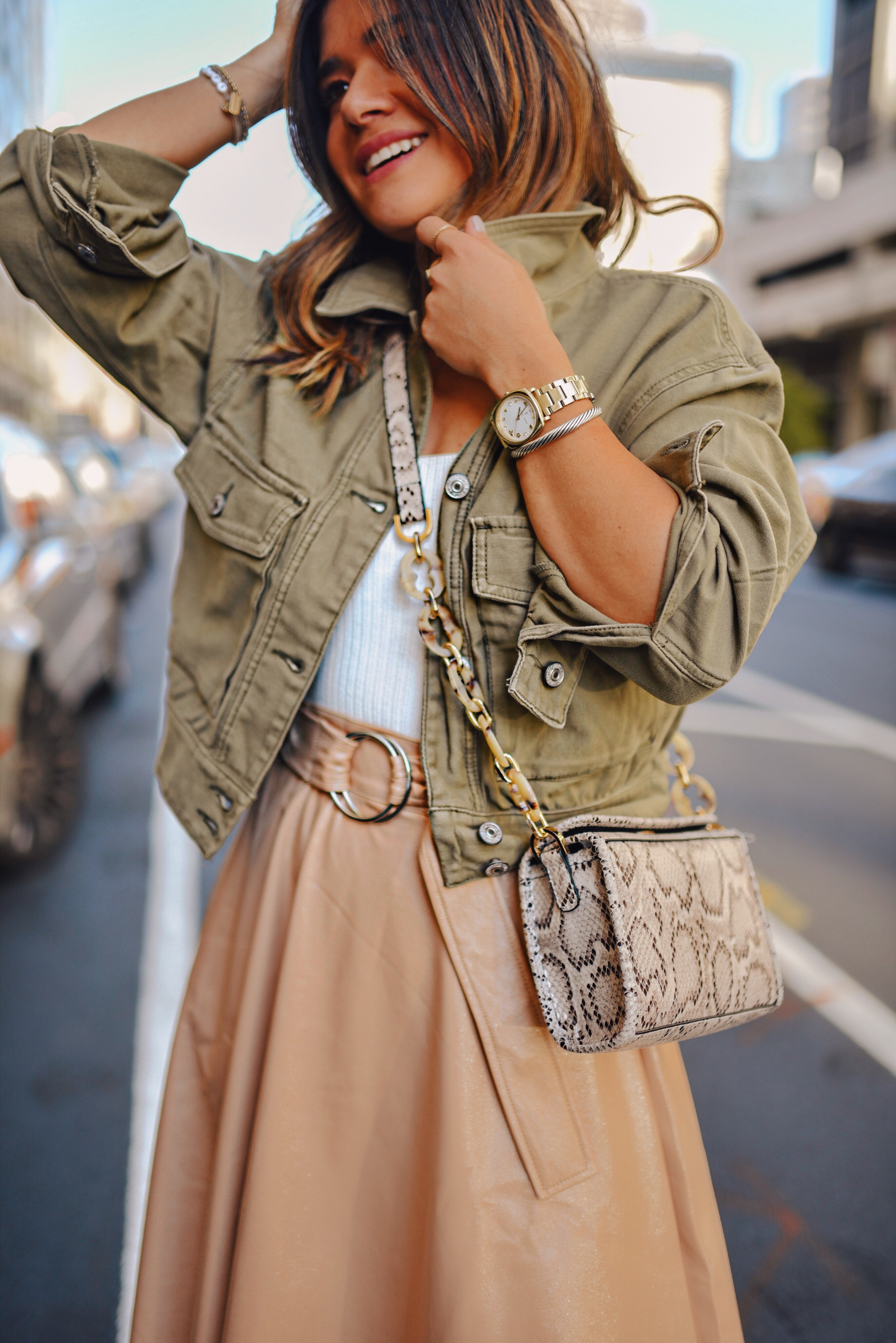 Carolina Hellal of Chic Talk wearing a Topshop white bodysuit, beige faux leather midi skirt, Abercrombie jacket, and Vici suede beige ankle boots. 
