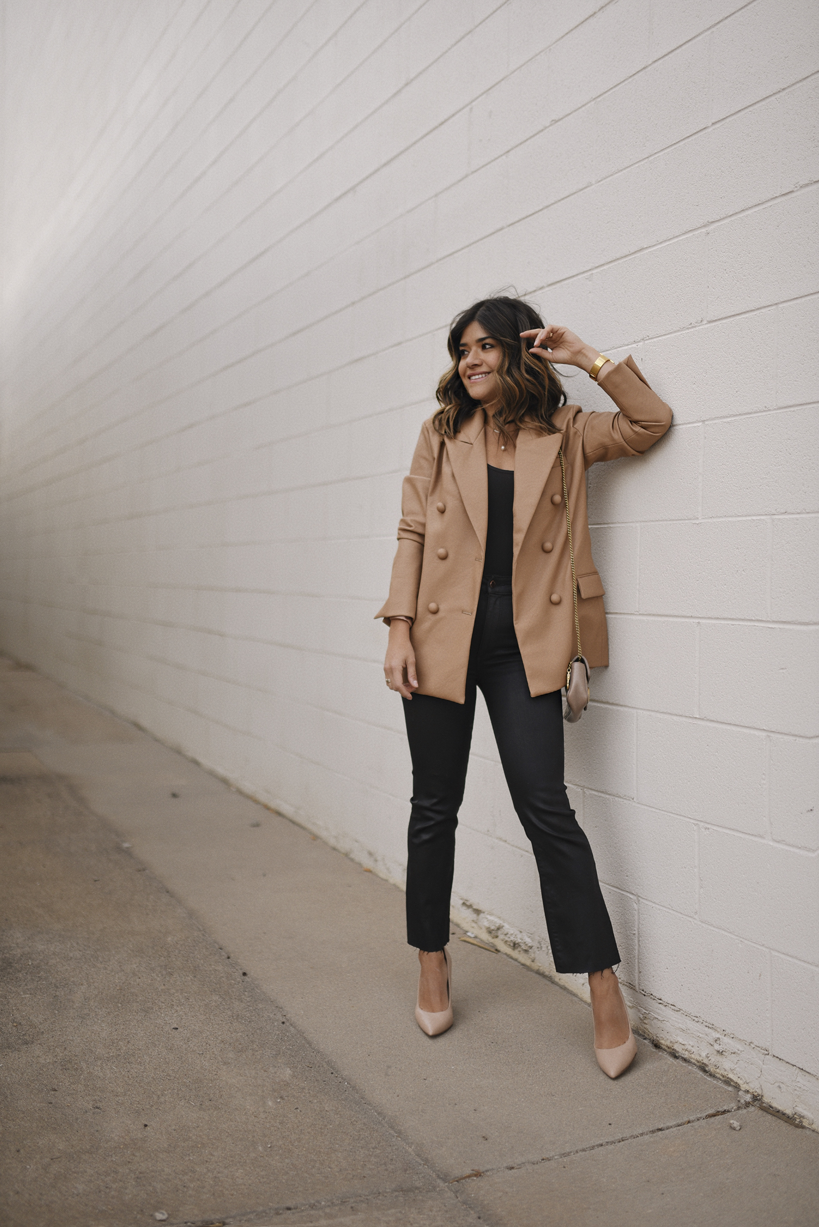 Carolina Hellal of Chic Talk wearinga BLANKNYC faux leather blazer, DL1960 black coated jeans, Nine West nude pumps and Gucci mini marmont bag