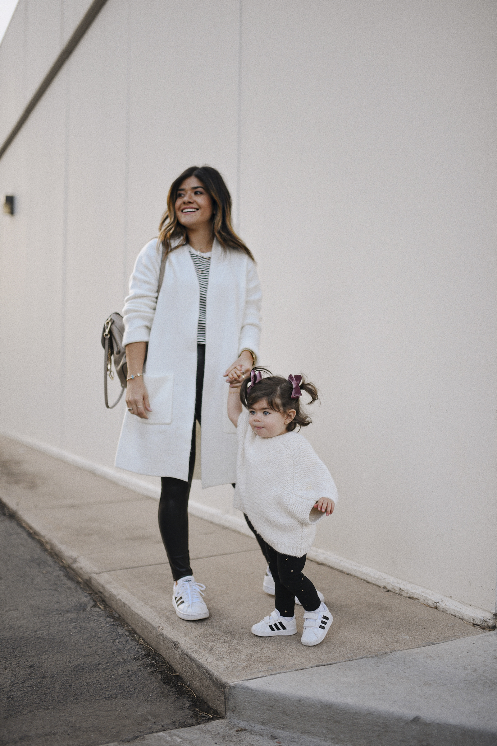 Carolina Hellal of Chic Talk and her daughter Sofia Jaramillo-Hellal wearing matching outfits in Adidas white sneakers