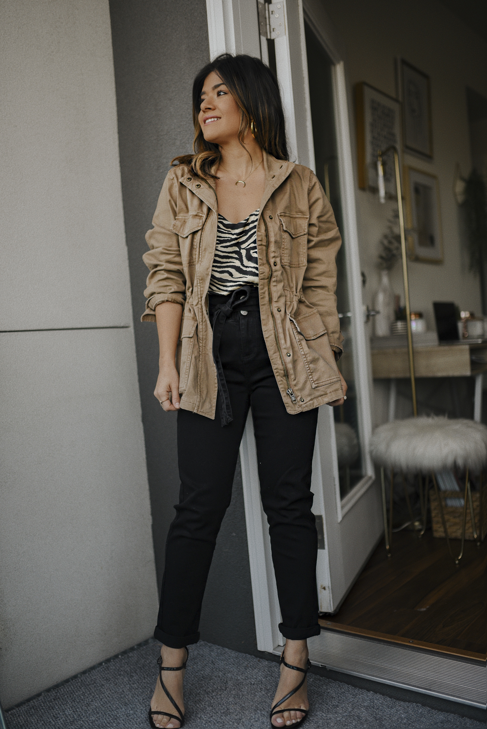 Carolina Hellal of Chic Talk wearing a utility jacket, zebra print camisole and paperbag jeans via Walmart's spring merchandise. 