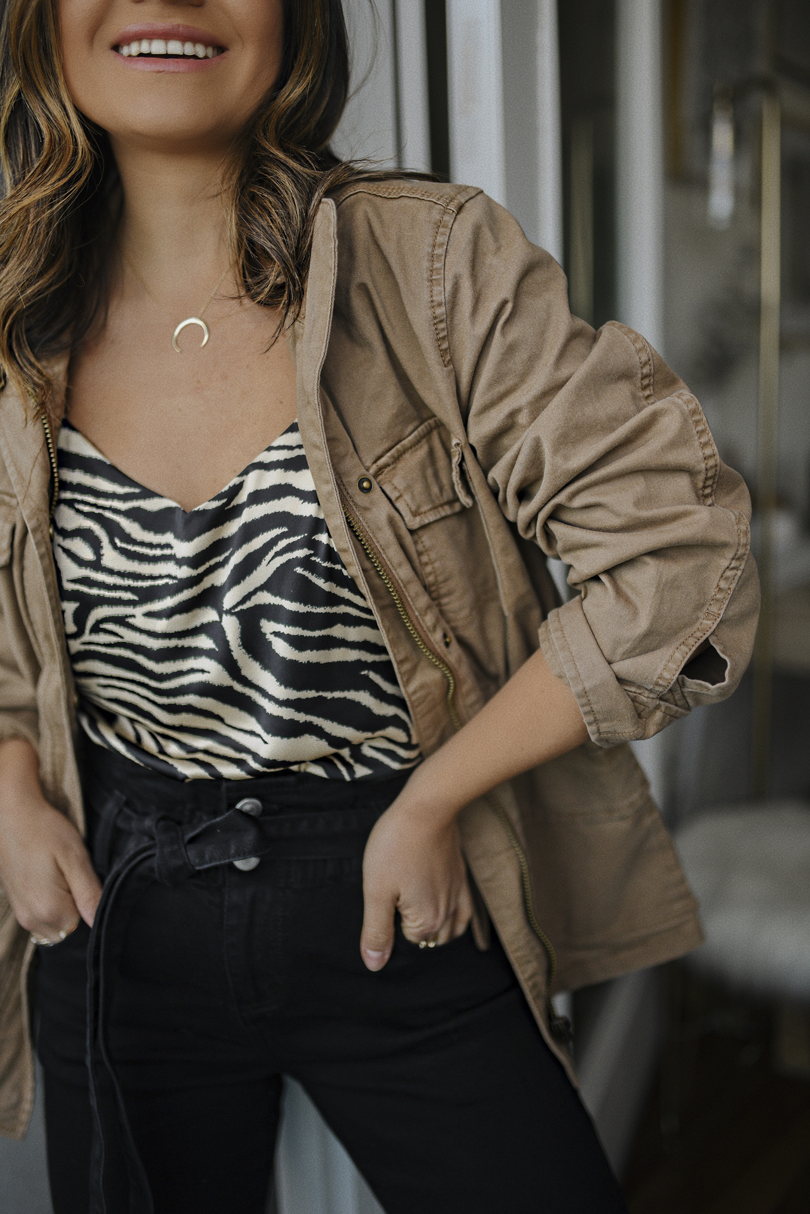 Carolina Hellal of Chic Talk wearing a utility jacket, zebra print camisole and paperbag jeans via Walmart's spring merchandise. 