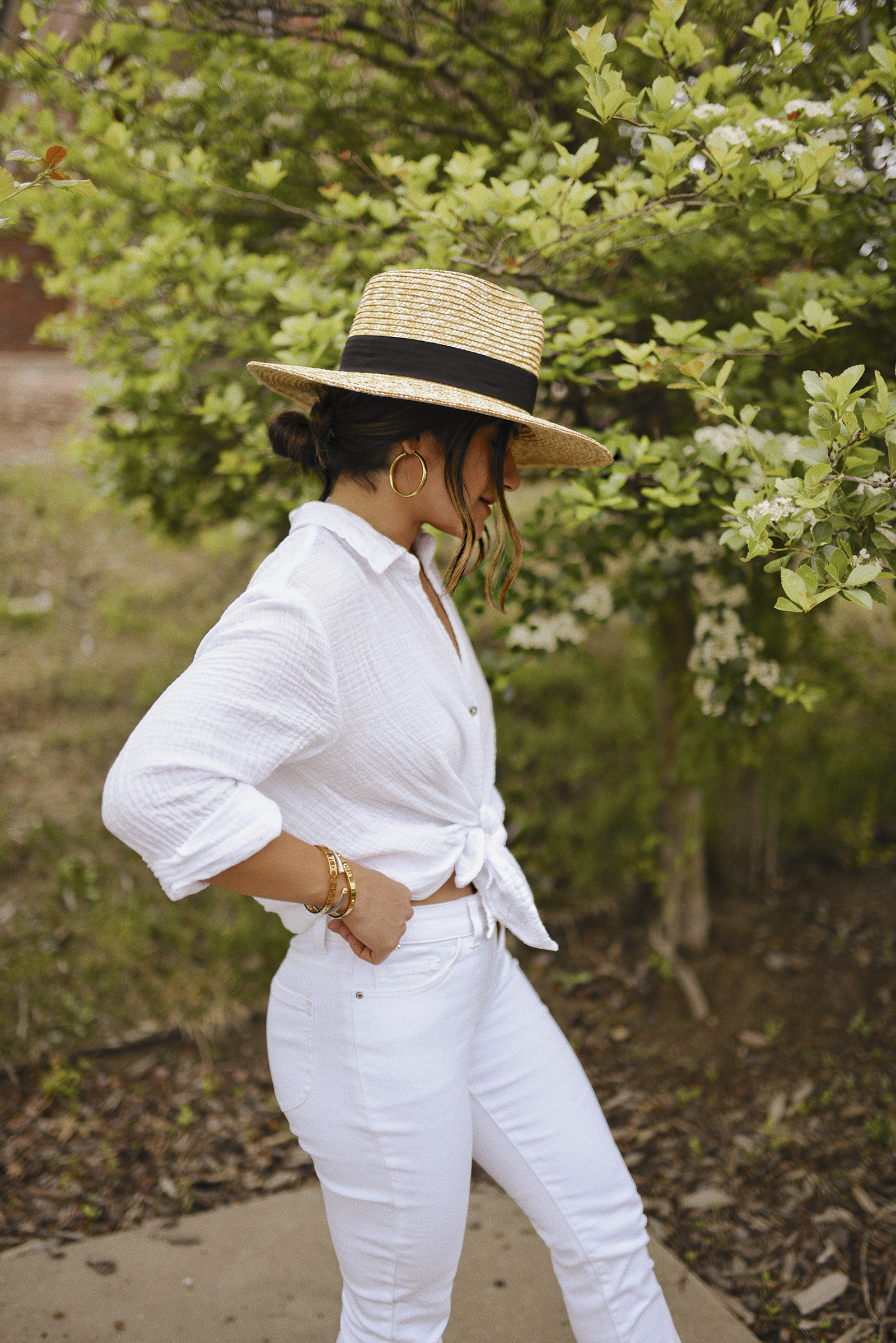 Carolina Hellal wearing a Michael Stars white button down, LEE white jeans, sun hat and Soludos sandals