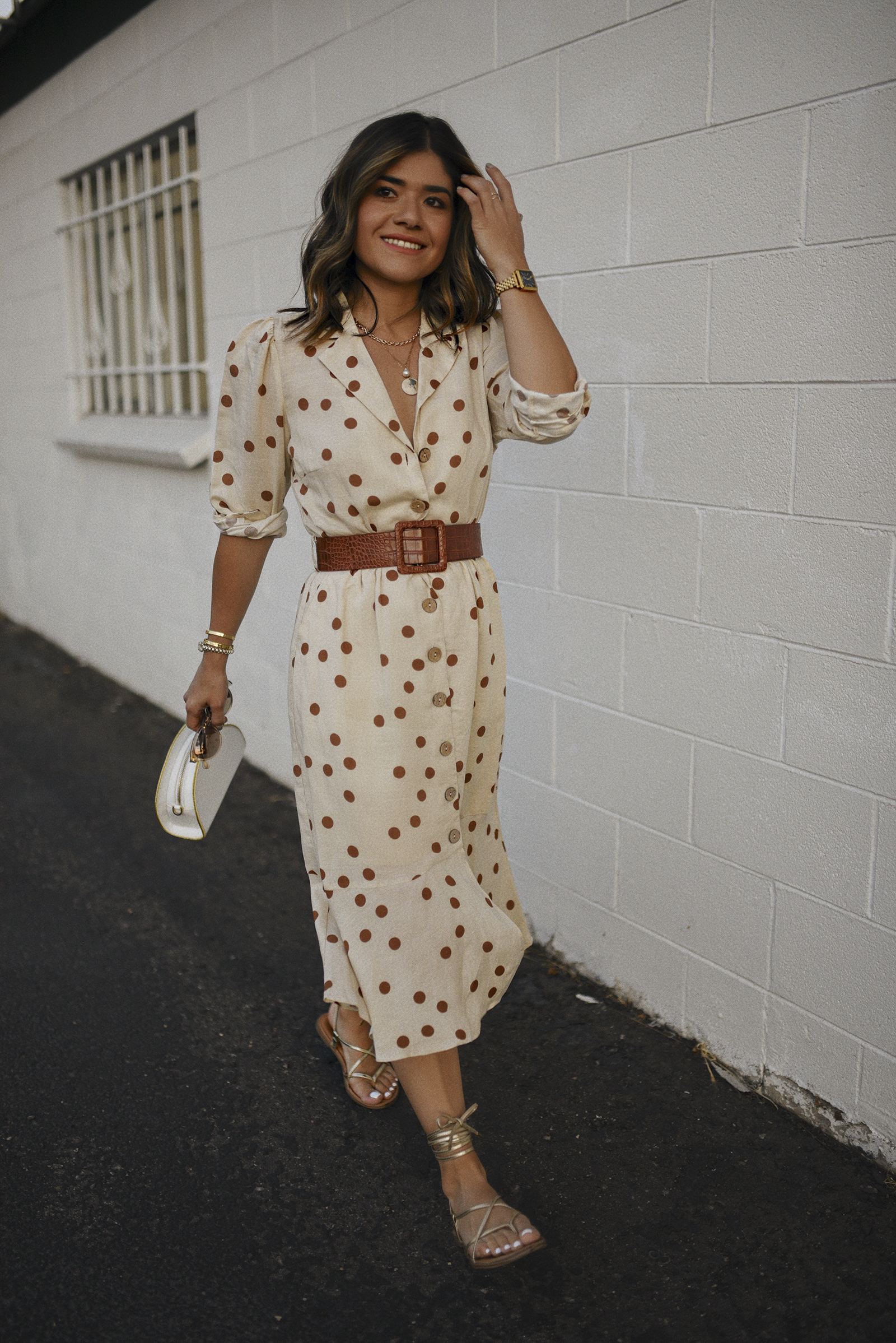 Carolina Hellal of Chic Talk wearing a Lucy Paris Polka dot midi dress, Irridescense white bag, Scoop gold lace up sandals and RAEN sunglasses