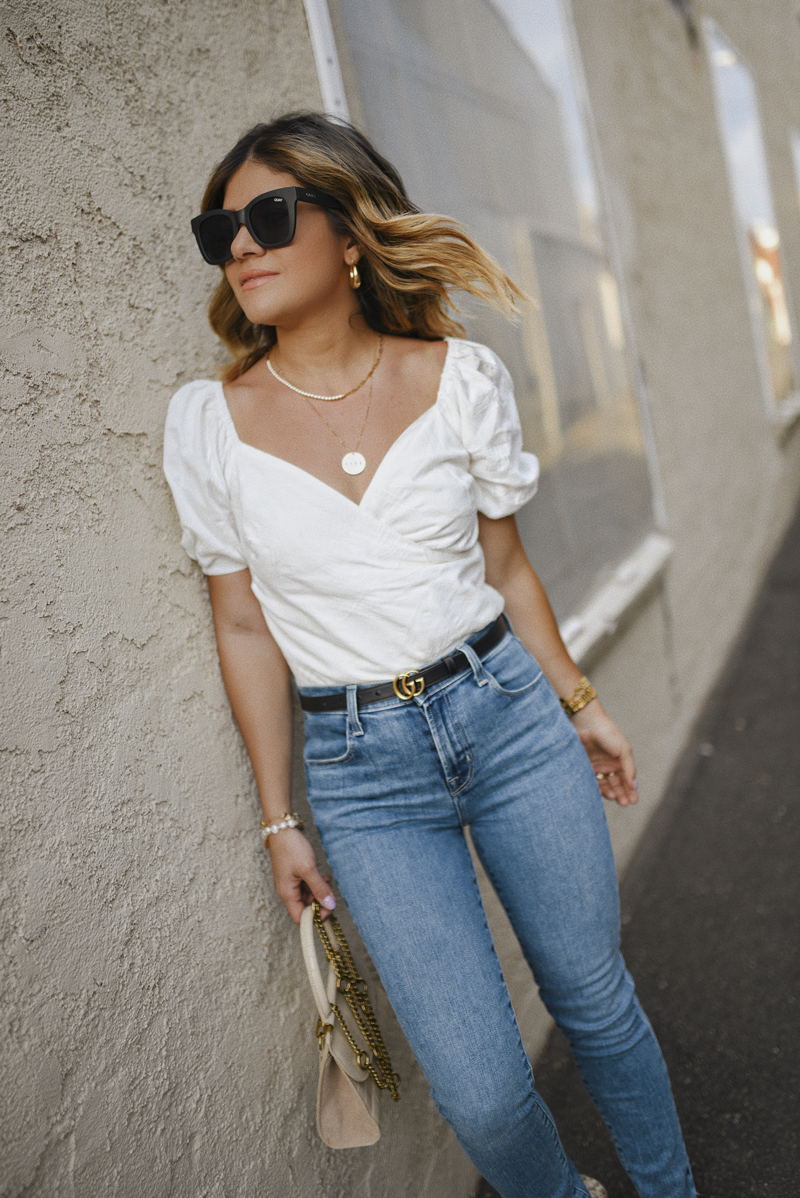 Carolina Hellal of Chic Talk wearing a Lucy Paris white top, Jbrand skinny jeans, Quay sunglasses and Gucci belt 