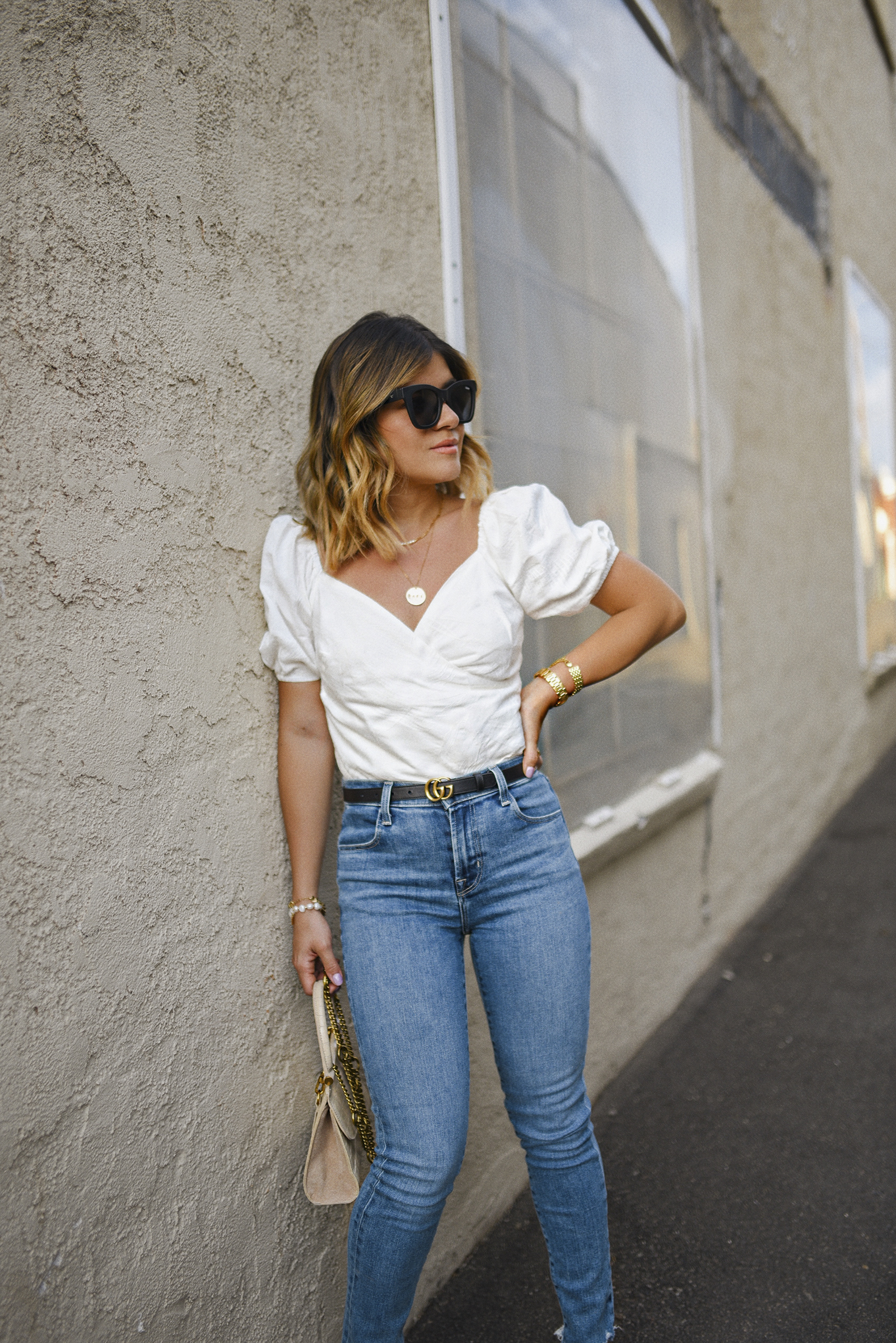 Carolina Hellal of Chic Talk wearing a Lucy Paris white top, Jbrand skinny jeans, Quay sunglasses and Gucci belt 