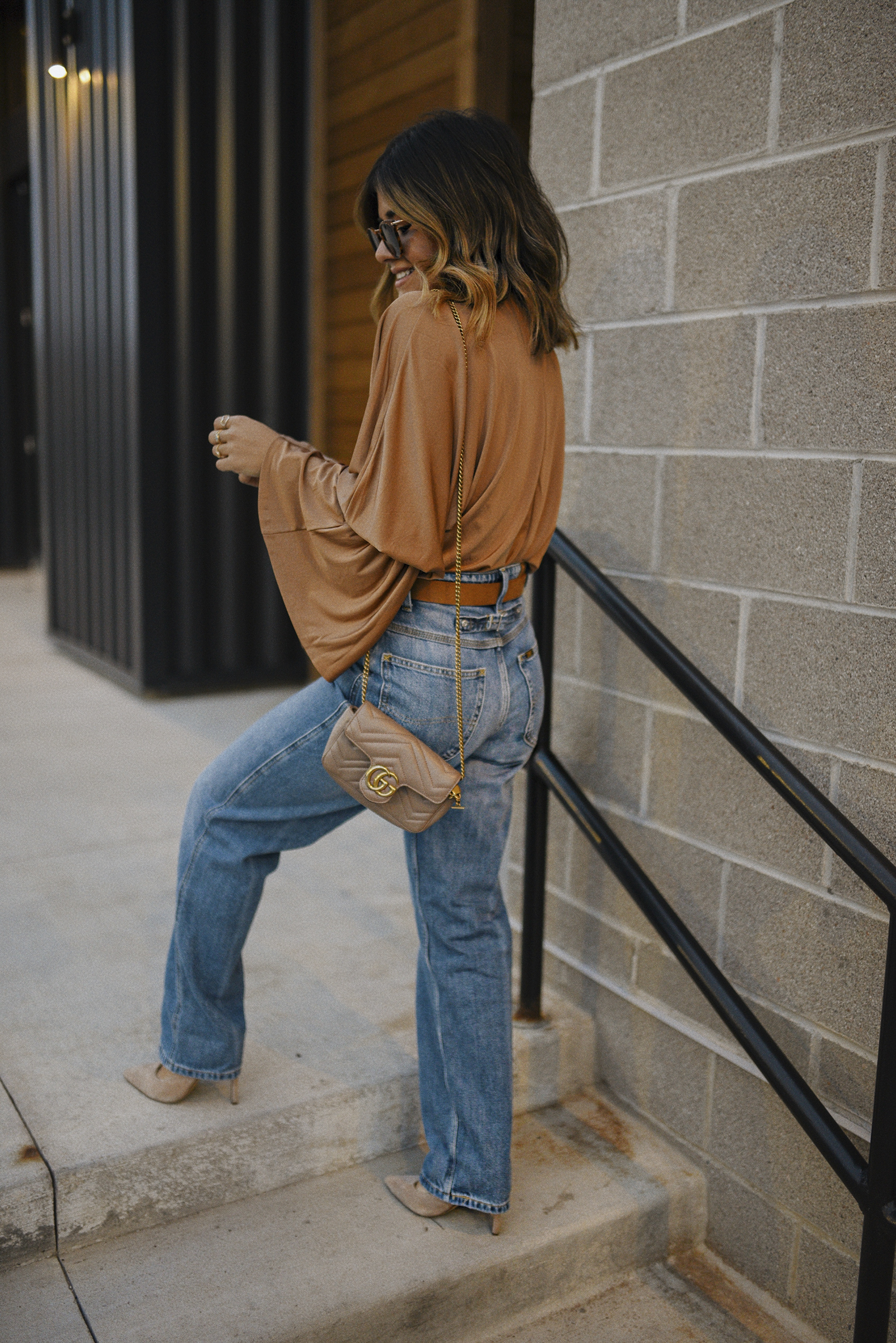 Carolina Hellal of Chic Talk wearing a fall outfit with a Express bodysuit, LEE jeans, Steve Madden suede pumps and Gucci handbag