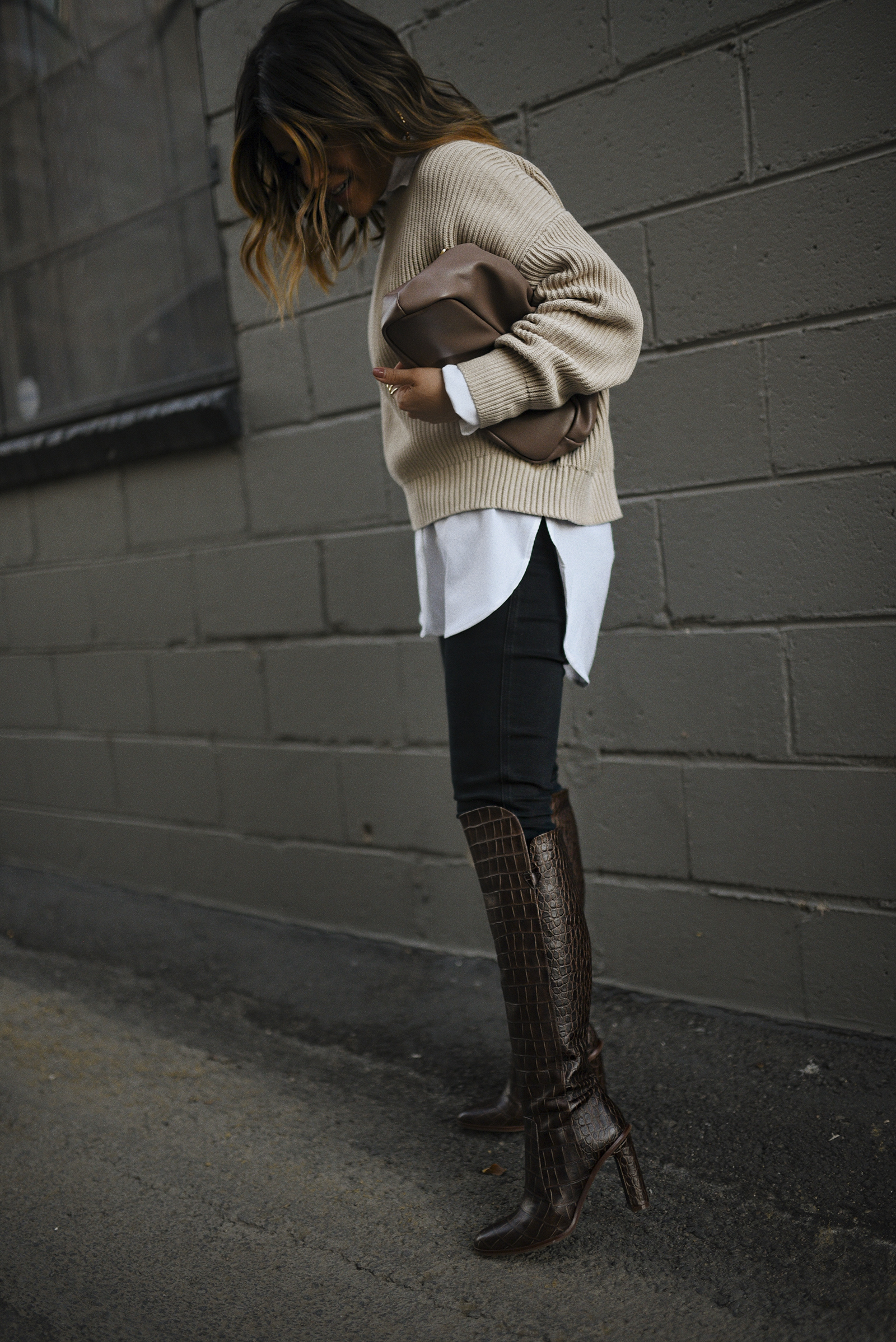 Carolina Hellal of Chic Talk wearing a Michael Stars knit sweater, Paige black skinny jeans, Vince Camuto croc-embossed boots and Target pouch bag. 