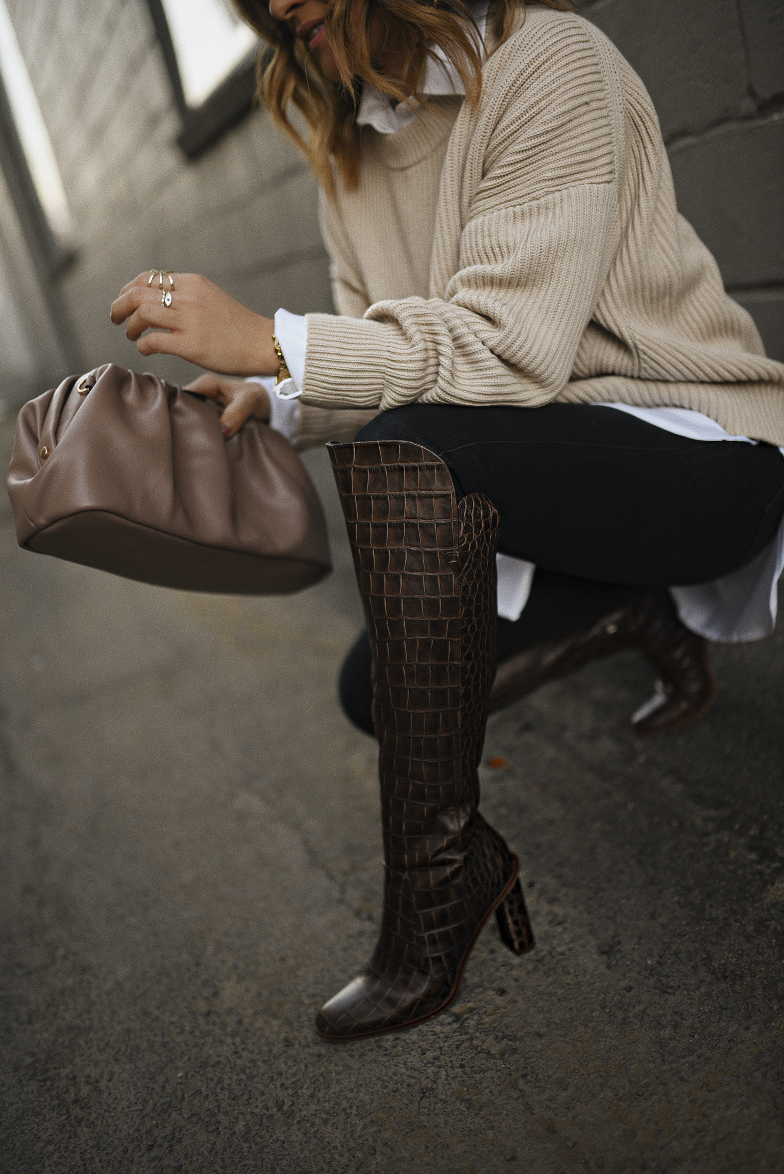 Carolina Hellal of Chic Talk wearing a Michael Stars knit sweater, Paige black skinny jeans, Vince Camuto croc-embossed boots and Target pouch bag. 