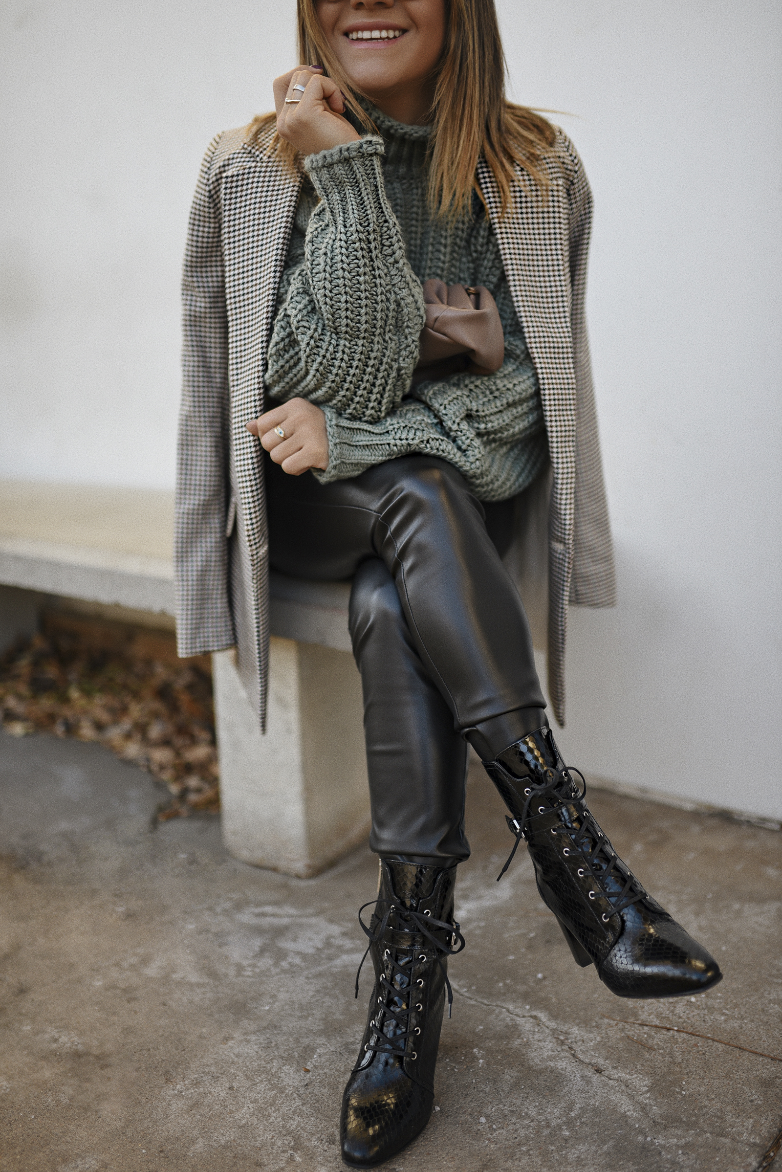 Carolina Hellal of Chic Talk wearing an H&M knit sweater, plaid blazer, Sofia Jeans vegan leather pants and Aquatalia lace up boots.