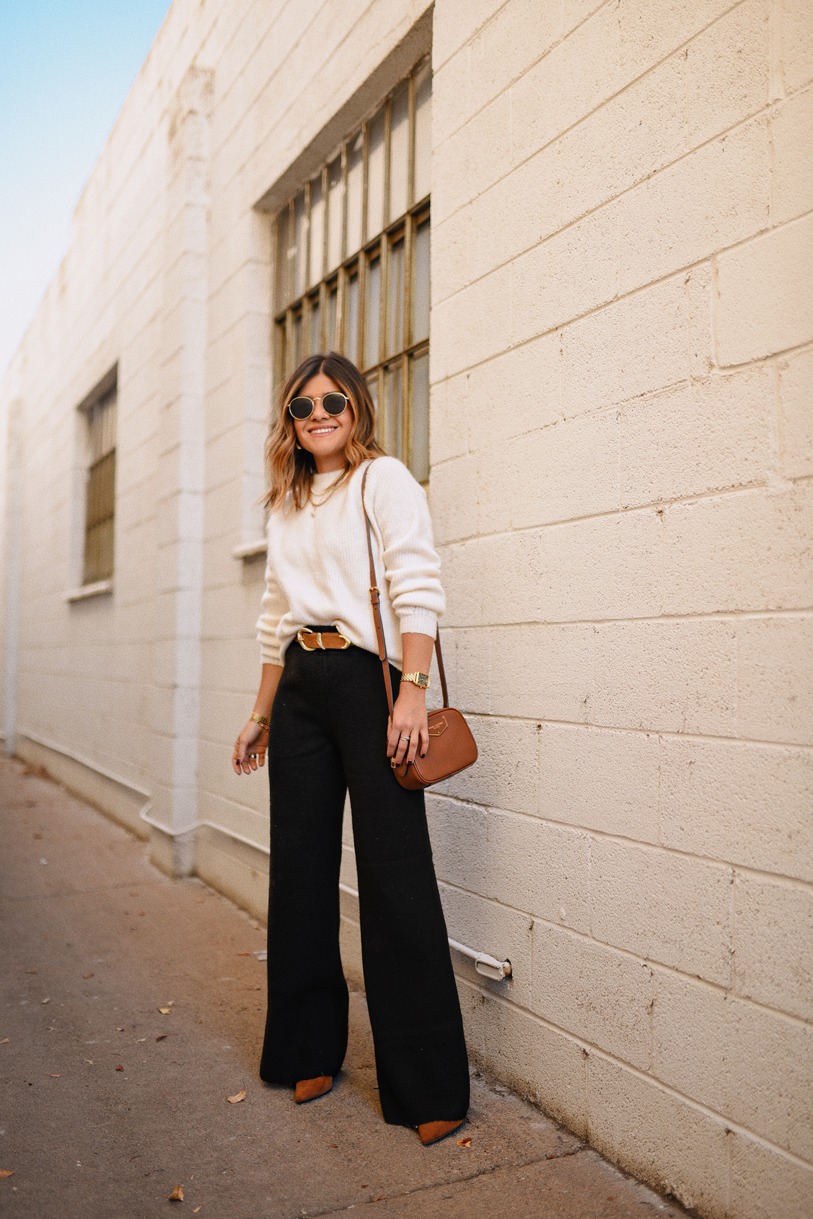 Carolina Hellal of Chic Talk wearing a Marc & Spencer white knit sweater, Express knit wide leg pants ,Steve Madden suede pumps and Marc Jacobs crossbody bag.