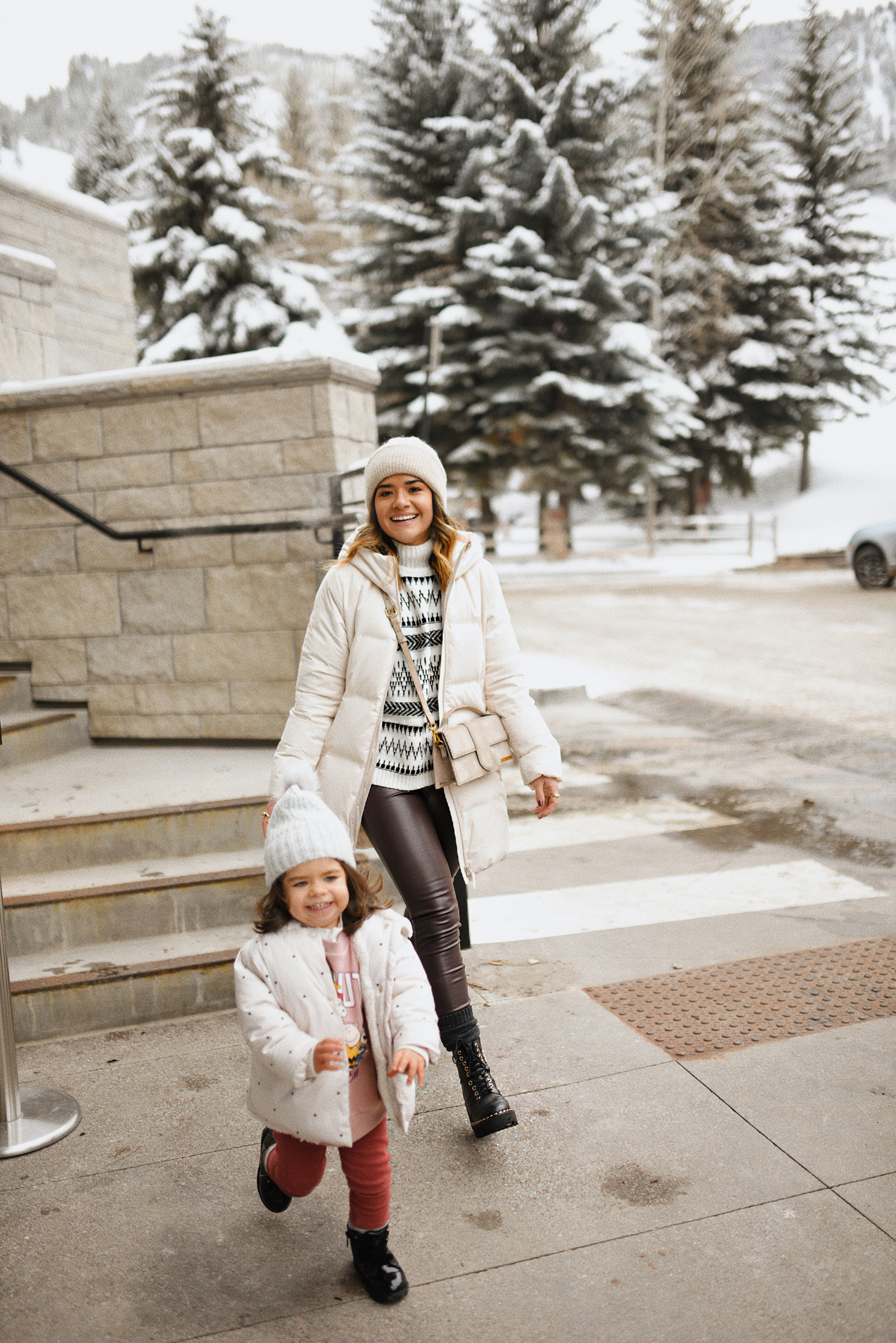 Carolina Hellal and her daughter Sofia at the W Aspen wearing winter outfits with puffer coats and combat boots. 
