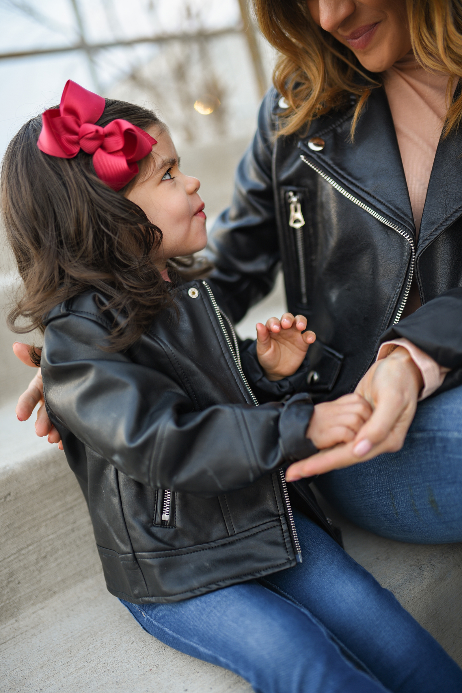 Carolina Hellal of Chic Talk wearing a matching biker jacket and combat boot outfits with her daughter Sofia. 