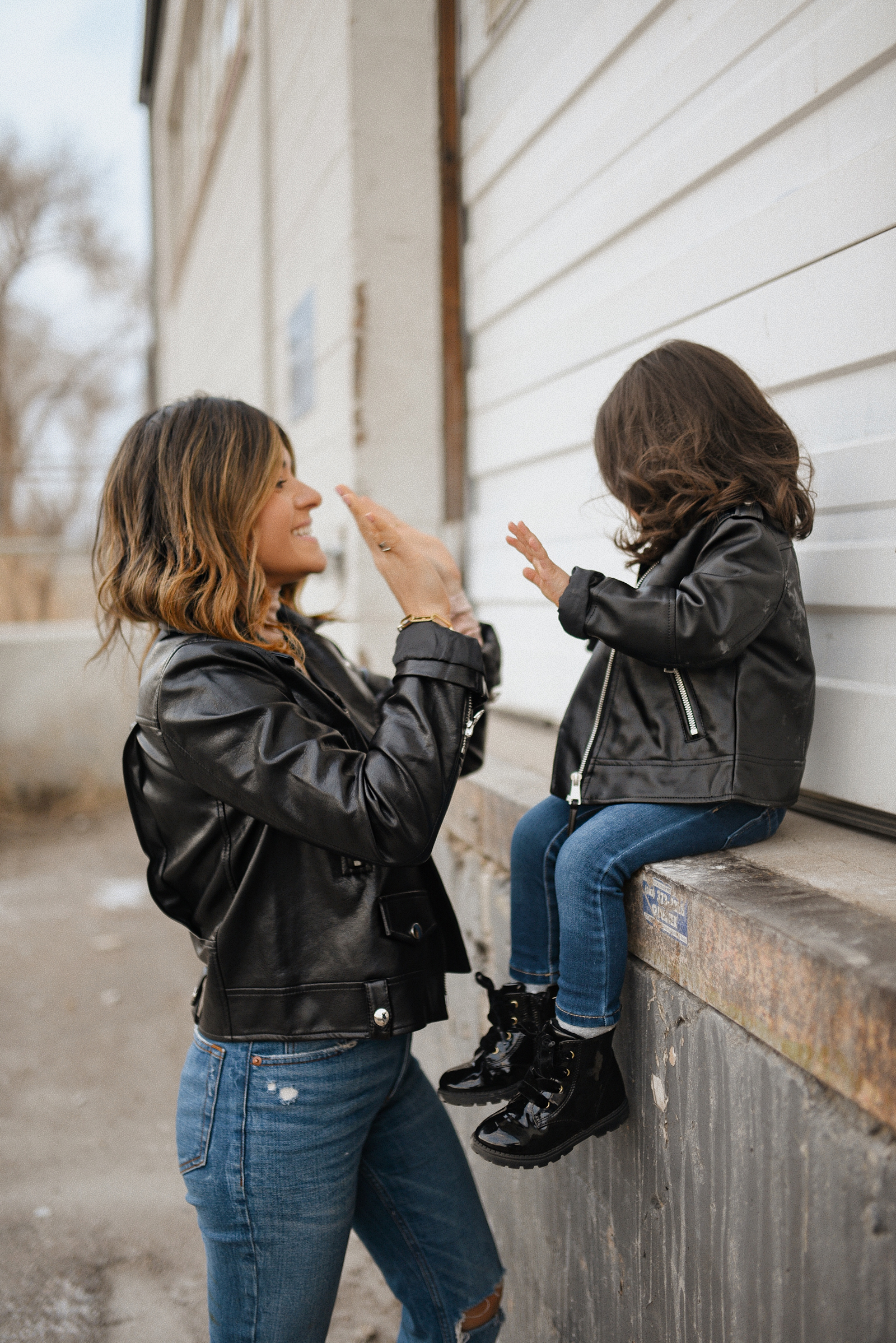 Carolina Hellal of Chic Talk wearing a matching biker jacket and combat boot outfits with her daughter Sofia. 