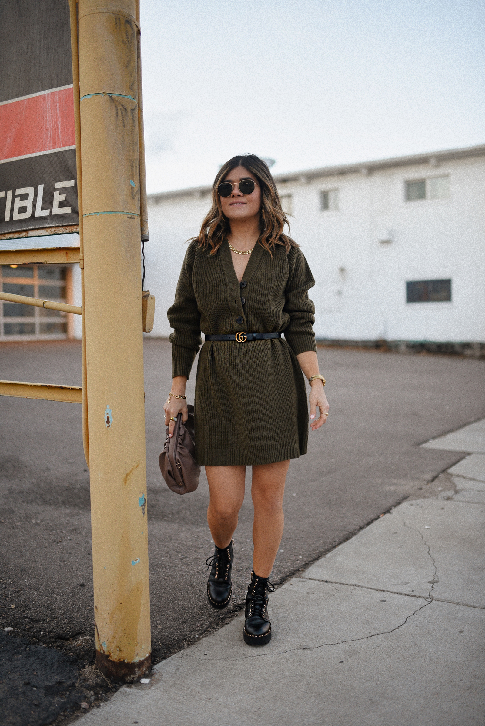 Carolina Hellal of Chic Talk wearing a Madewell sweater dress, Vince Camuto chunky boots, Rayban sunglasses and Target pouch bag. 