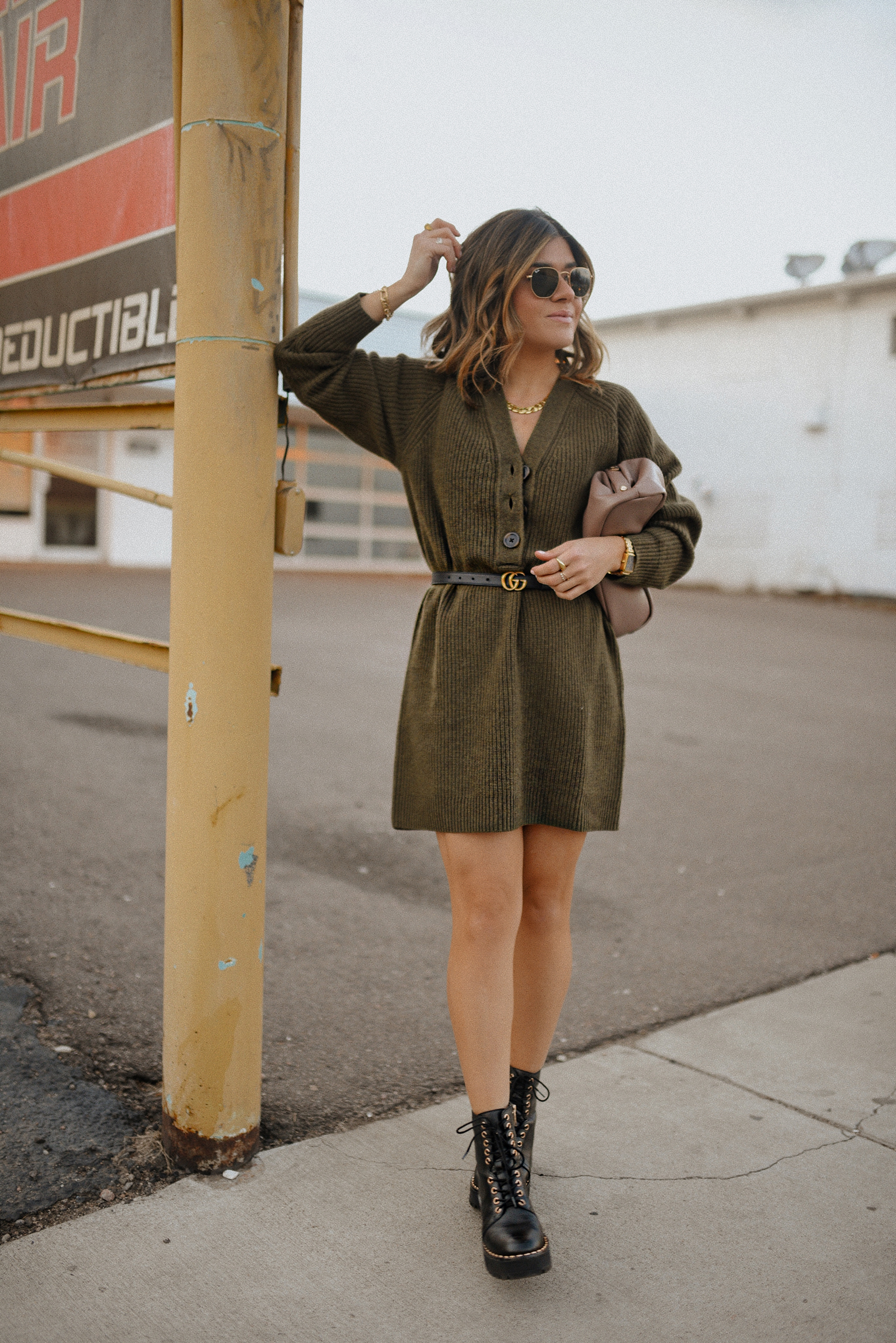 Carolina Hellal of Chic Talk wearing a Madewell sweater dress, Vince Camuto chunky boots, Rayban sunglasses and Target pouch bag. 