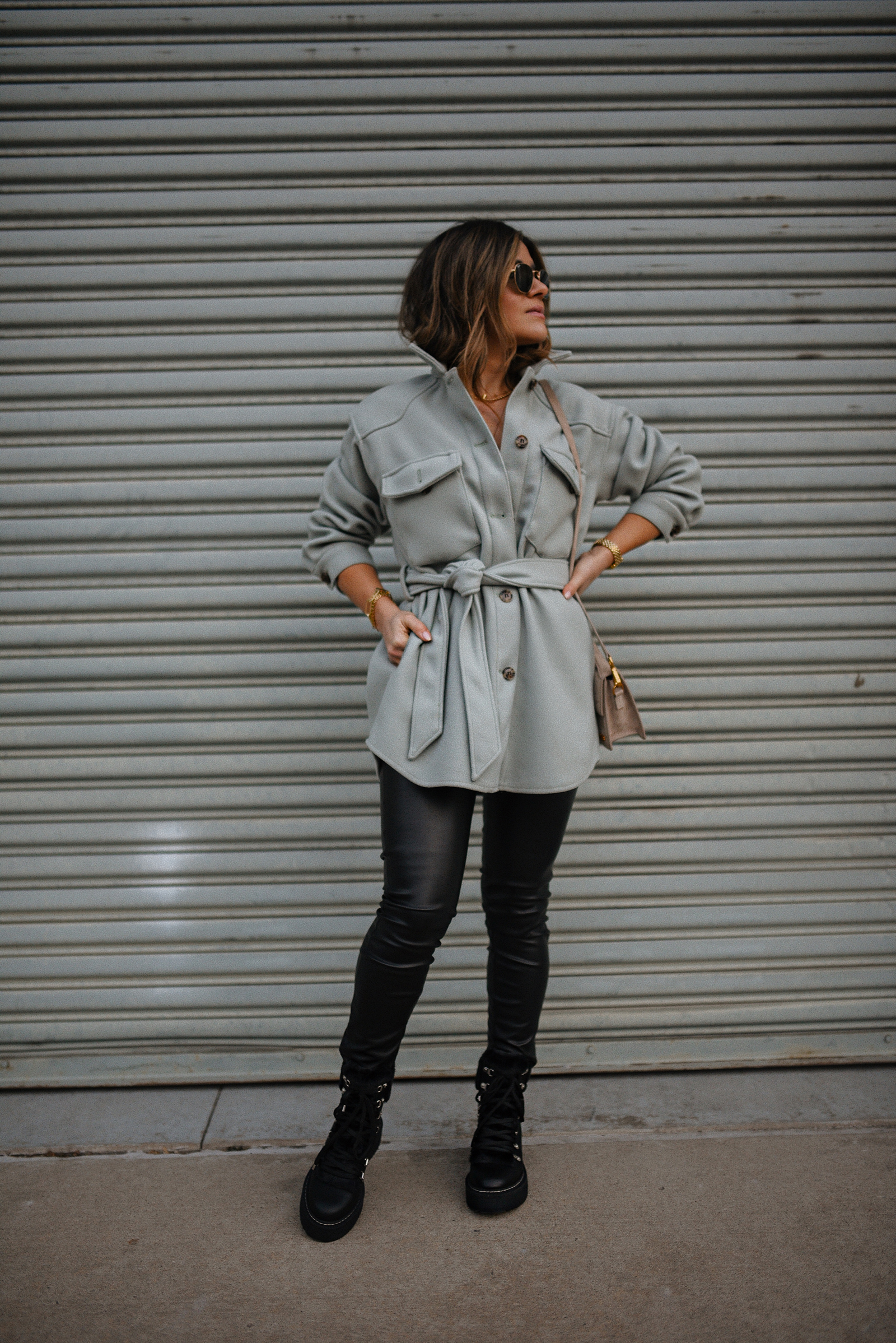 Carolina Hellal of Chic Talk wearing a shacket, faux leather pants and combat boots. 