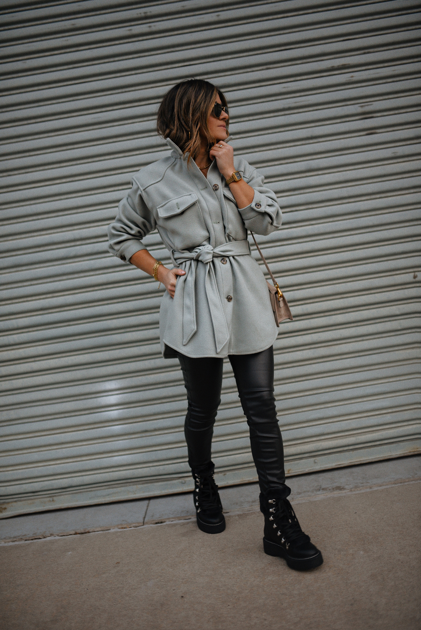 Carolina Hellal of Chic Talk wearing a shacket, faux leather pants and combat boots. 