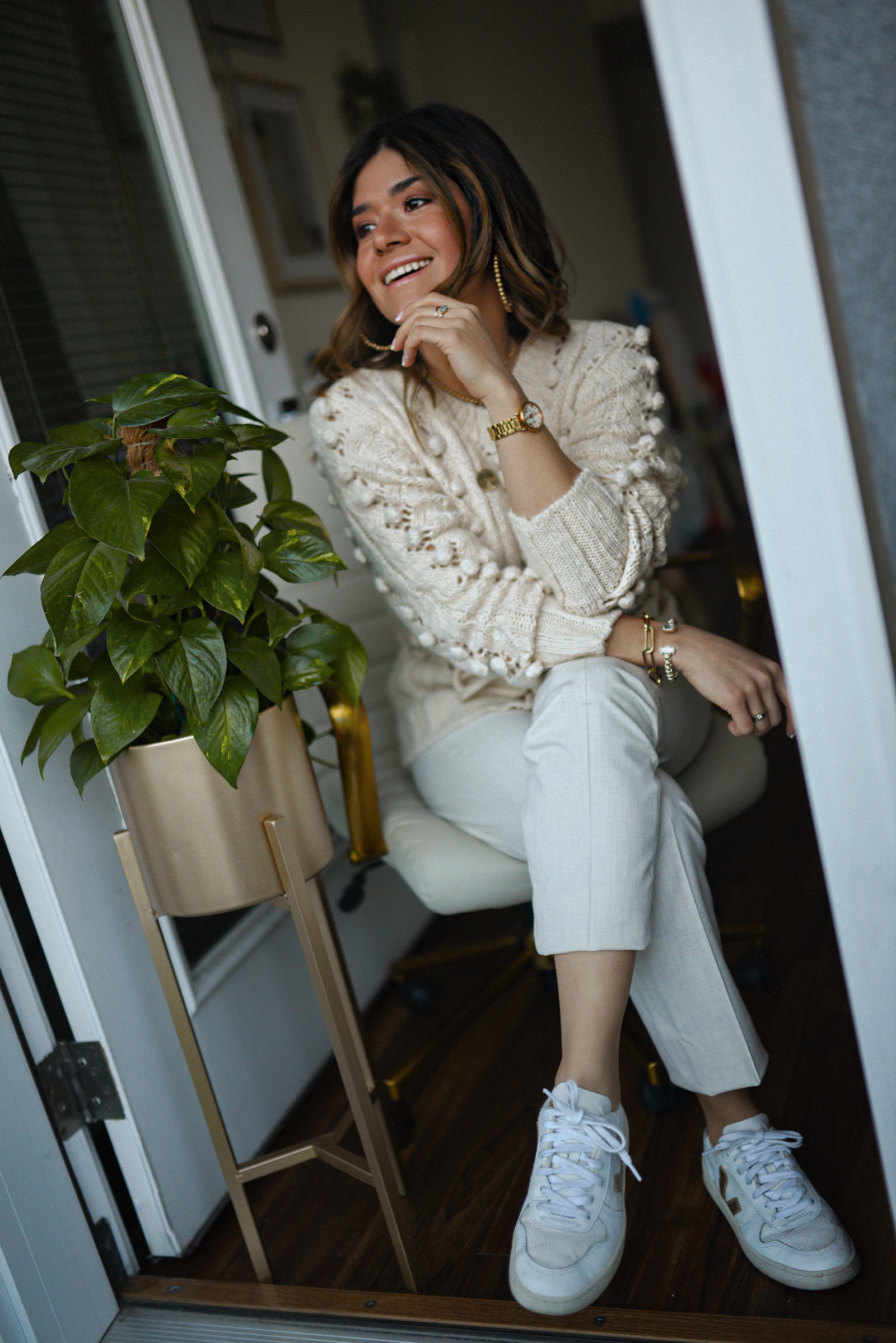 Carolina Hellal of Chic Talk wearing a Goodnight Macaroon pom pom sweater, Uniqlo beige trousers and Veja sneakers.