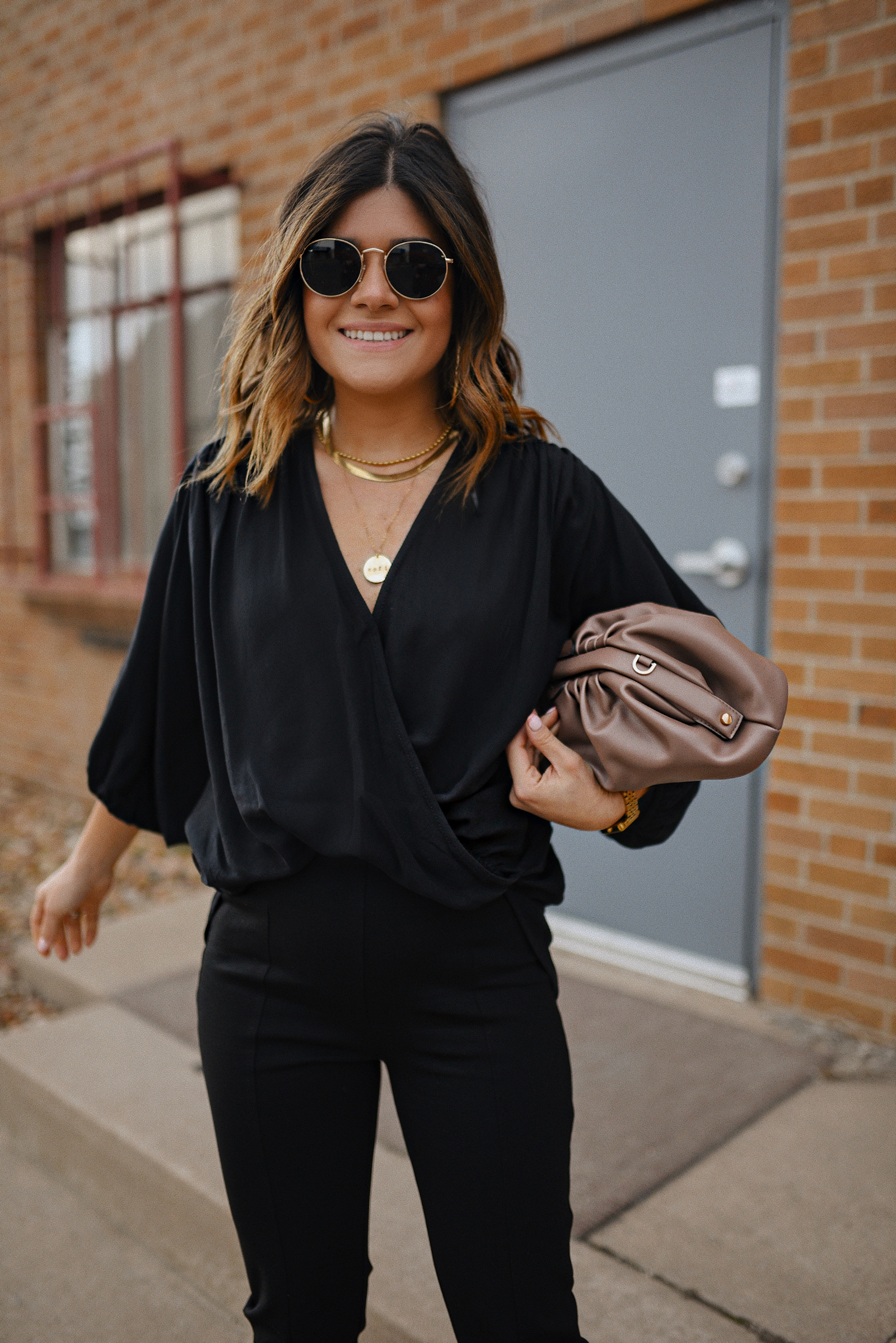 Carolina Hellal of Chic Talk wearing a total black look via Petal + Pup, animal print strap sandals and a pouch bag via Target. 
