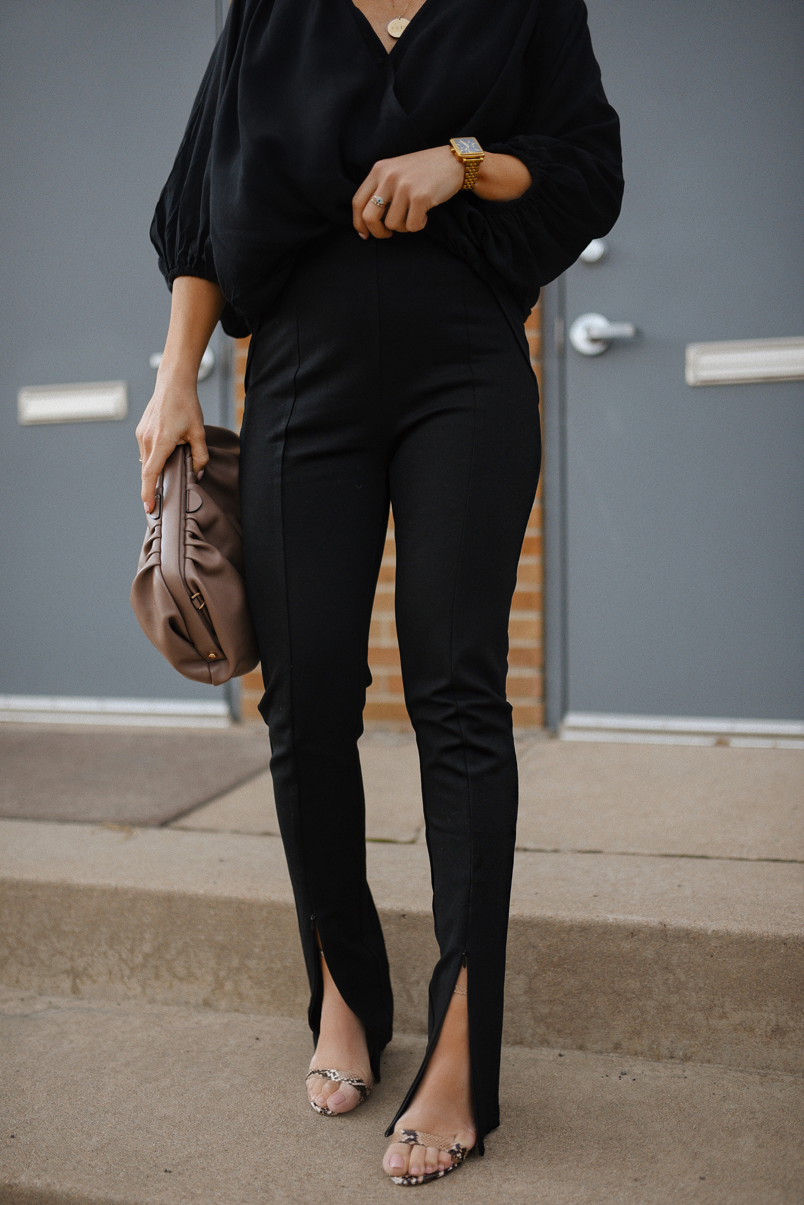 Carolina Hellal of Chic Talk wearing a total black look via Petal + Pup, animal print strap sandals and a pouch bag via Target. 
