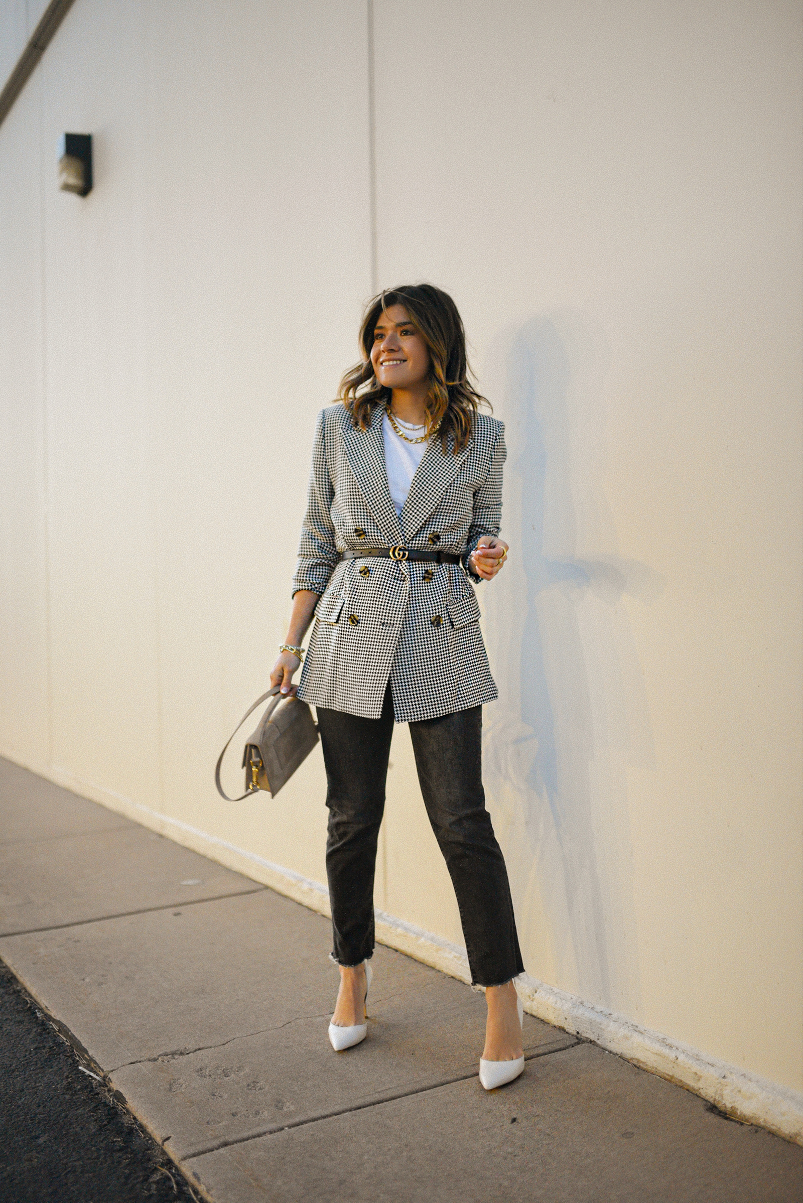 Carolina Hellal of Chic Talk wearing a WAYF plaid blazer, a white Abercrombie white t-shirt, Levi's jeans and Steve Madden white pumps. 