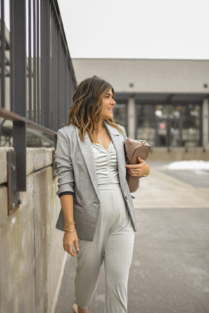 Carolina Hellal of Chic Talk wearing a gray blazer and gray jumpsuit via Express from their brand new Sueded silky jersey collection. 