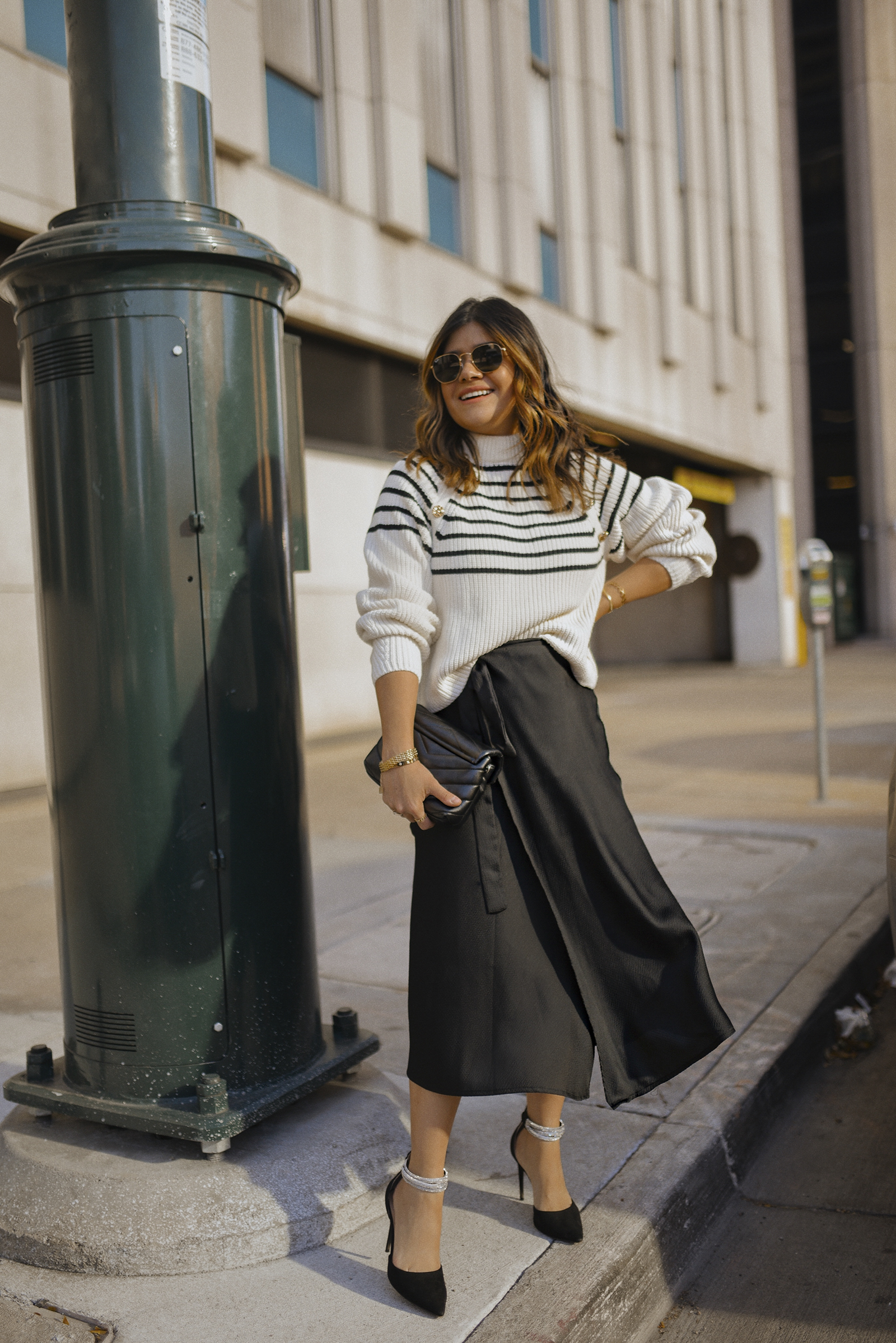 Carolina Hellal of Chic Talk wearing an H&M stripped sweater, Vici Dolls black midi skirt, JLO JENNIFER LOPEZ black pumsps via DSW and Rayban sunglasses