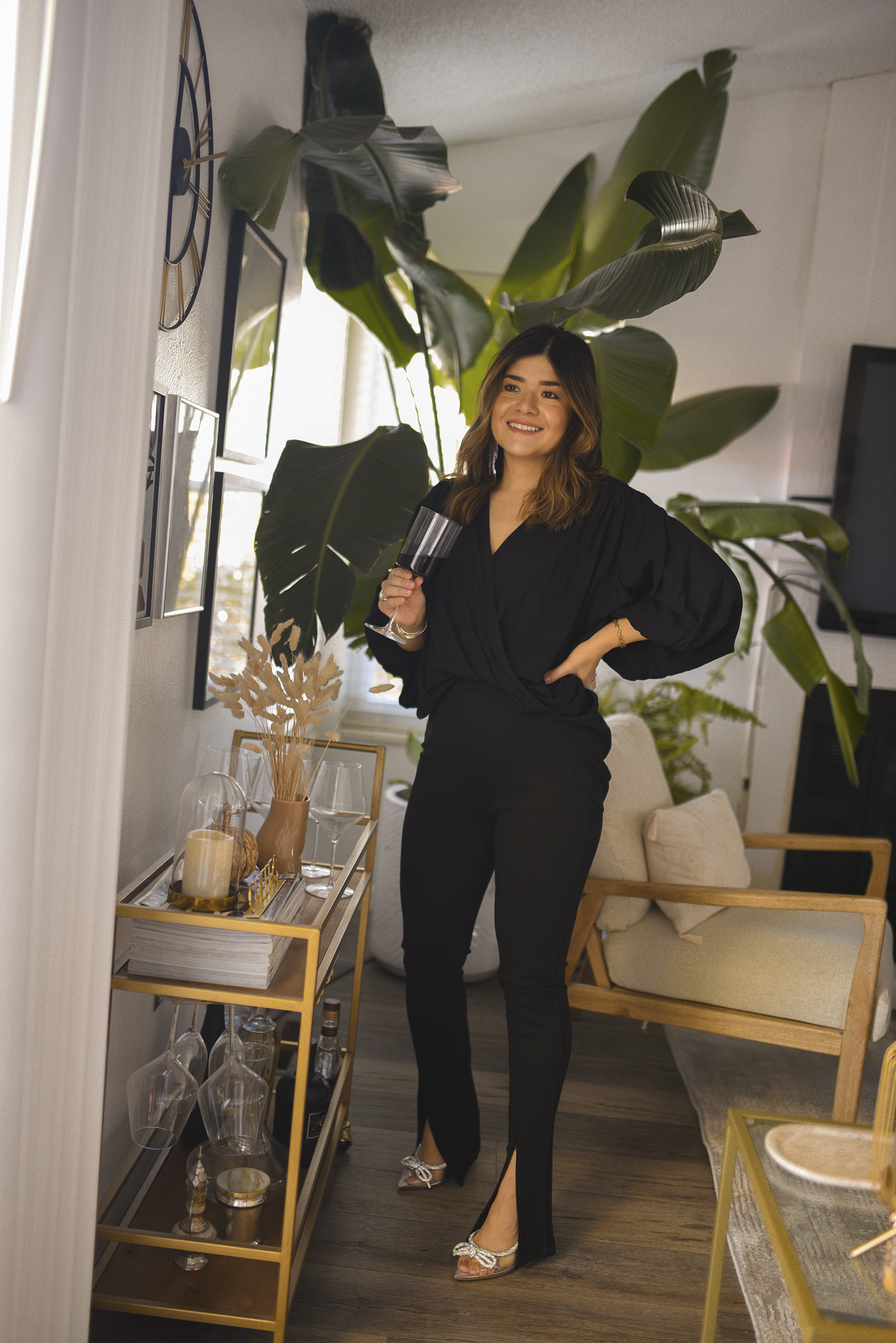 Carolina Hellal of Chic Talk wearing a total black look. Petal + Pup black wrap top, skinny black trouser with front slit and JLO Jennifer Lopez shimmery heels