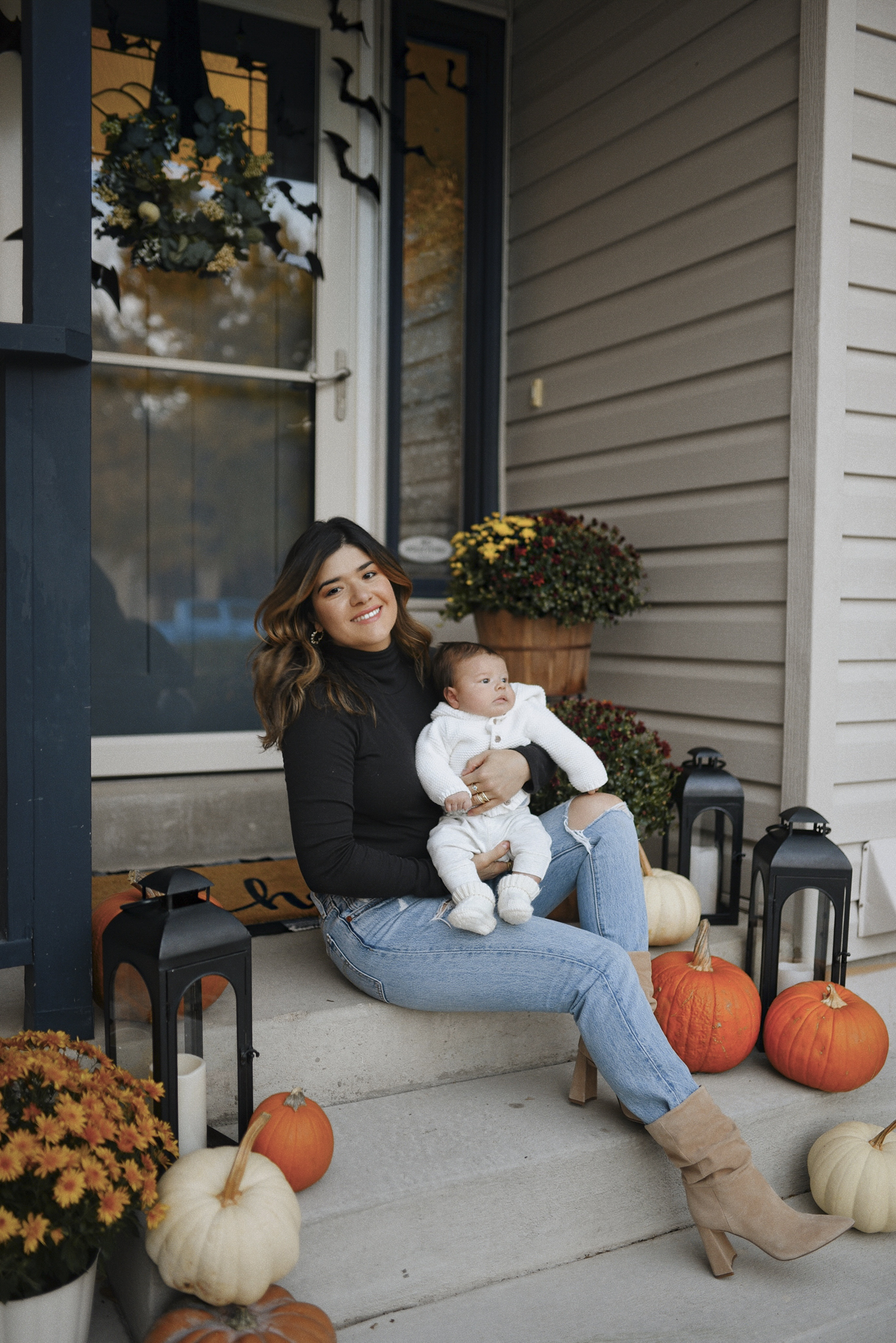 Carolina Hellal of Chic Talk wearing a Scoop black turtleneck sweater, Levi's 501 skinny jeans and Vince Camuto beige suede boots, her son Matias is wearing a cozy look via h&m