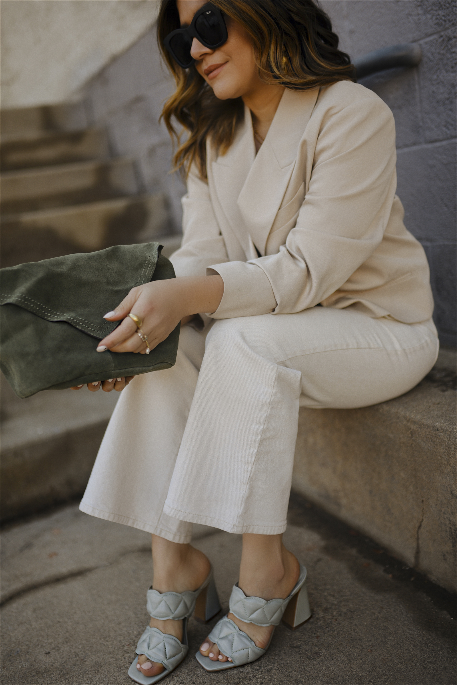 Carolina Hellal of Chic Talk wearing an H&M crop blazer, Wrangle crop jeans, Vince Camuto mules and suede bag and Quay sunglasses.