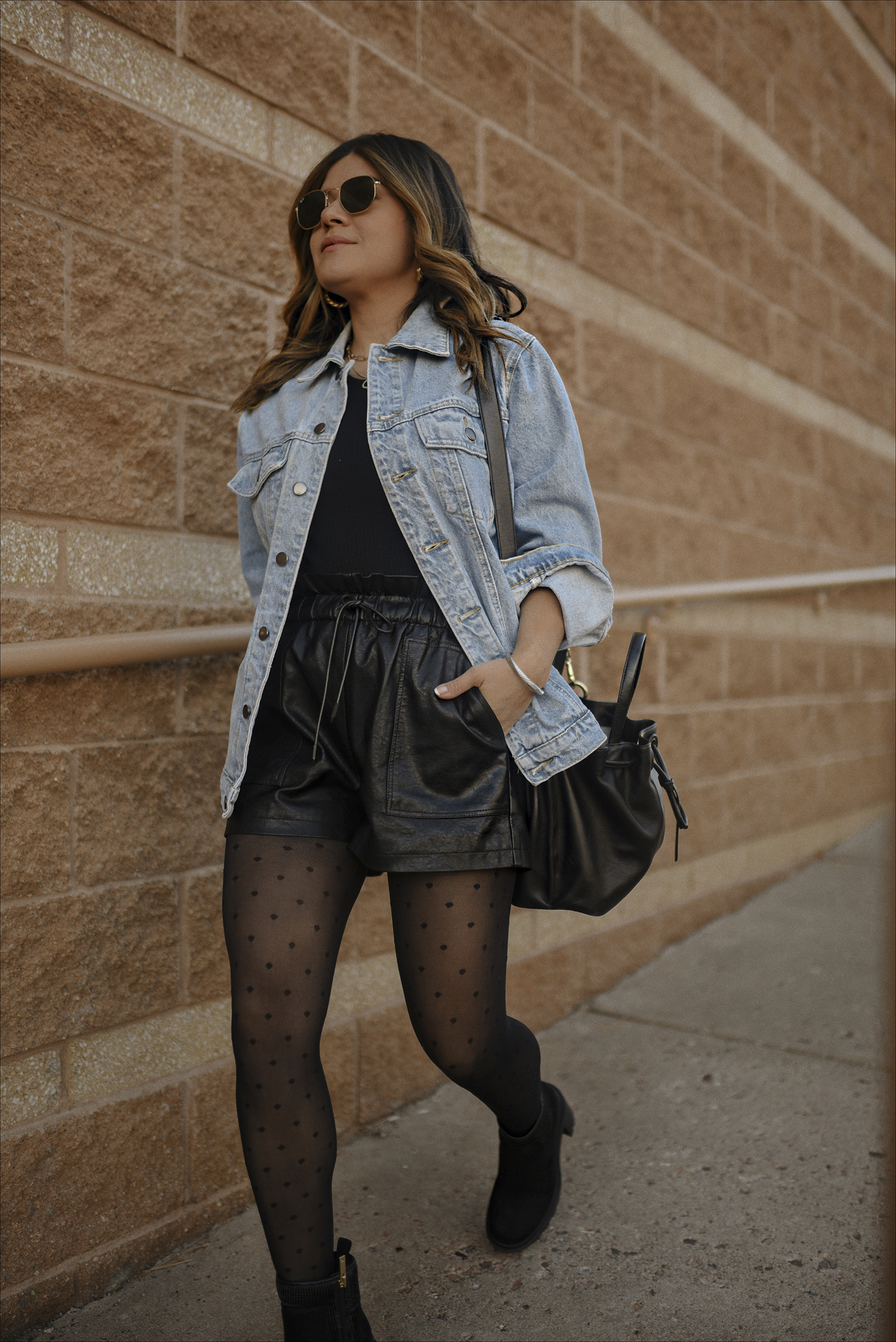 Carolina Hellal of Chic Talk wearing a Denim jacket, faux leather shorts via Amazon, JLO Jennifer lopez chunky boots and Cole Haan bucket bag