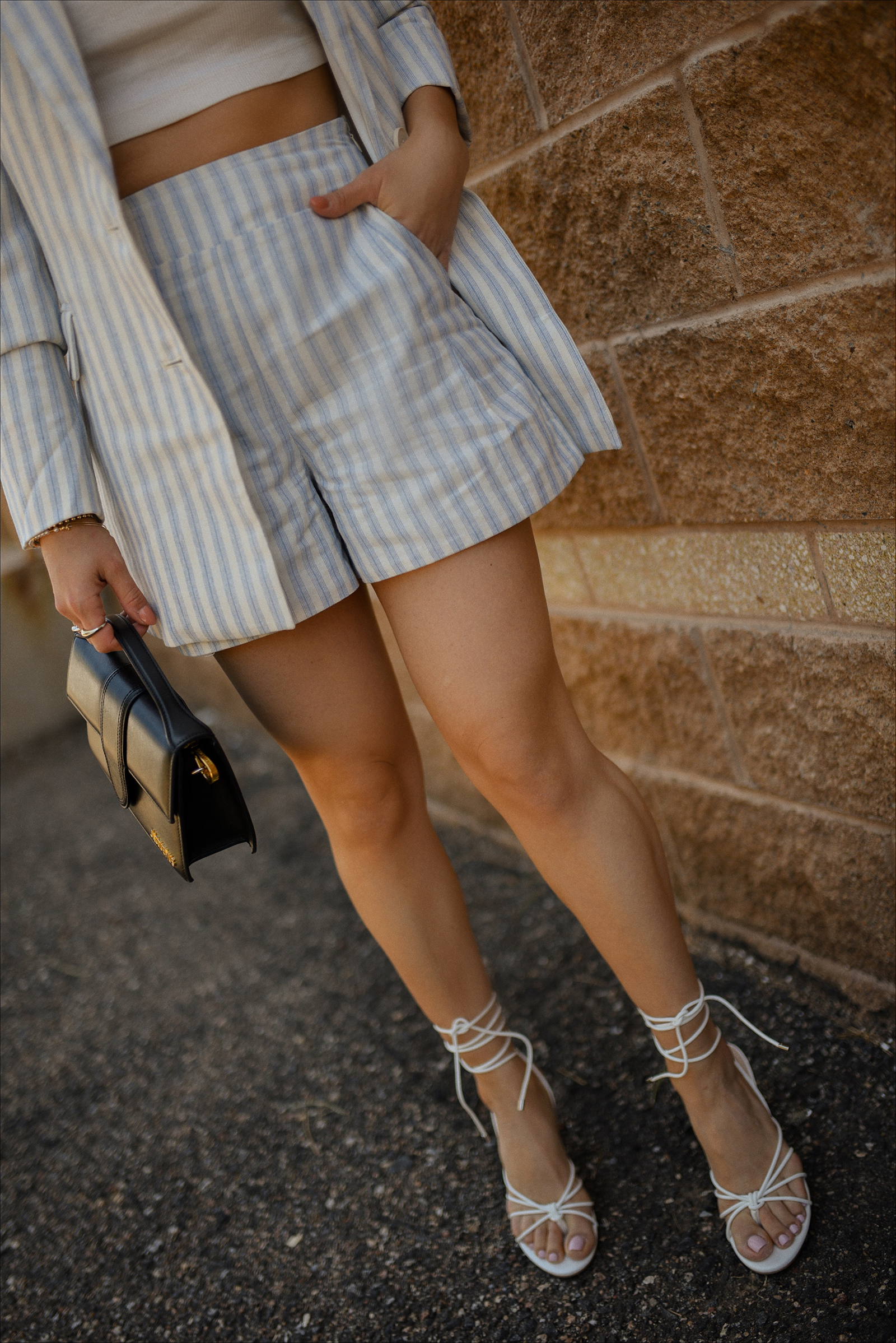 Carolina Hellal of Chic Talk wearing the prettiest blazer and shorts set via Gibsolook, lace-up sandals from Amazon, and a black Jacquemus Le Bambino Bag. 