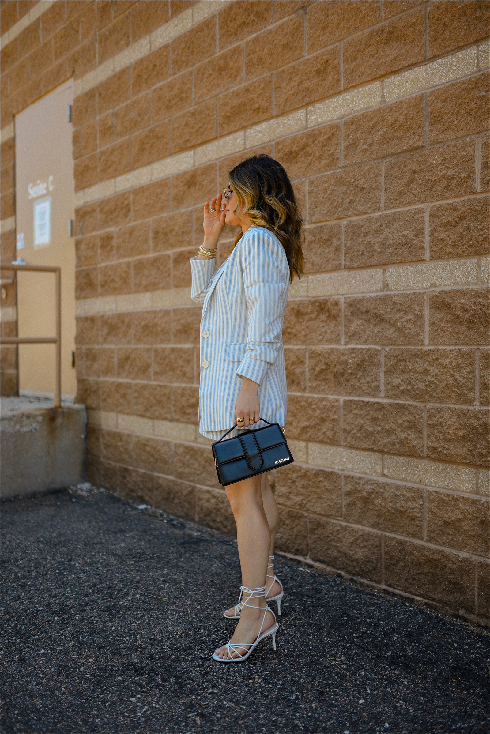 Carolina Hellal of Chic Talk wearing the prettiest blazer and shorts set via Gibsolook, lace-up sandals from Amazon, and a black Jacquemus Le Bambino Bag. 