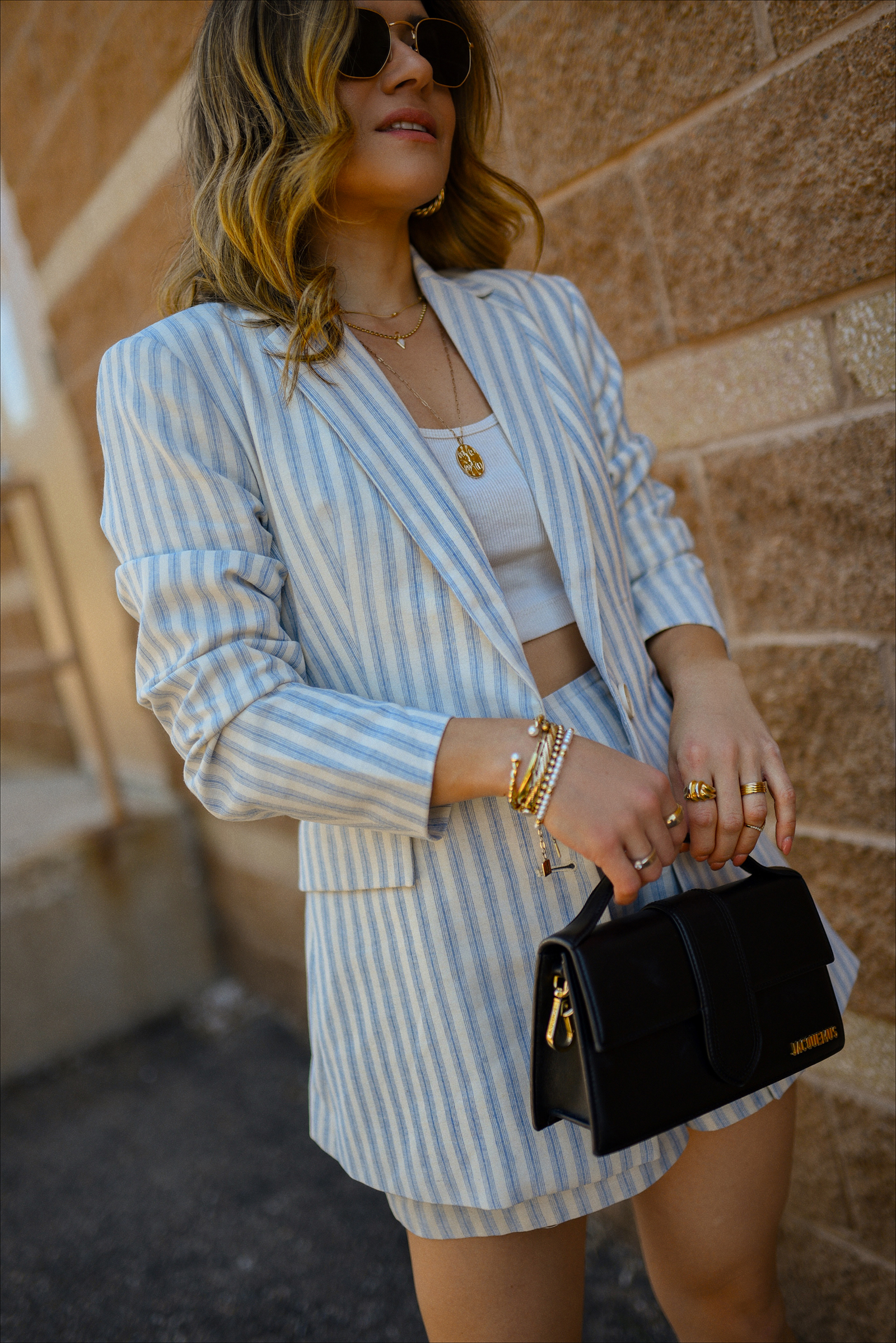 Carolina Hellal of Chic Talk wearing the prettiest blazer and shorts set via Gibsolook, lace-up sandals from Amazon, and a black Jacquemus Le Bambino Bag. 