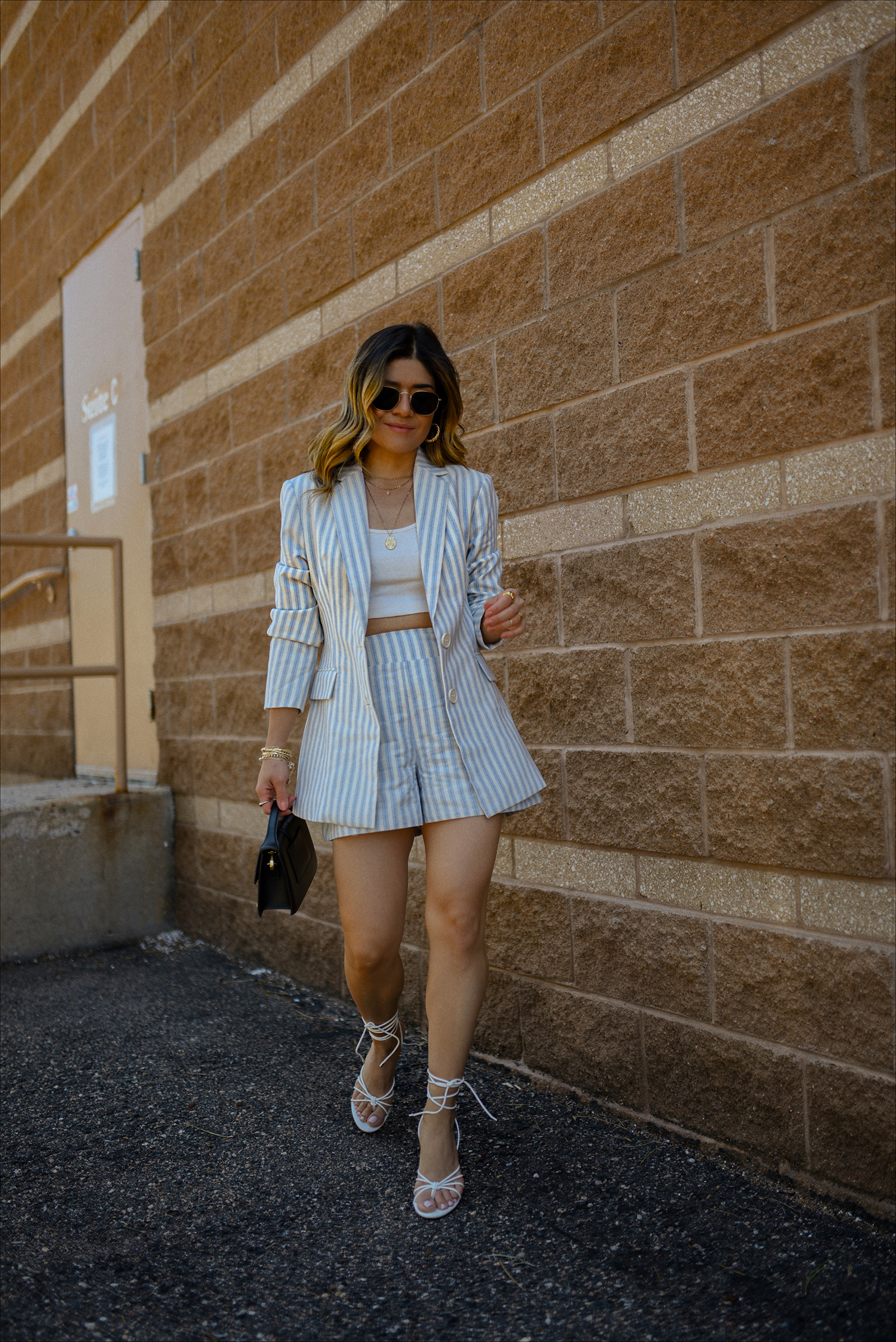 Carolina Hellal of Chic Talk wearing the prettiest blazer and shorts set via Gibsolook, lace-up sandals from Amazon, and a black Jacquemus Le Bambino Bag. 