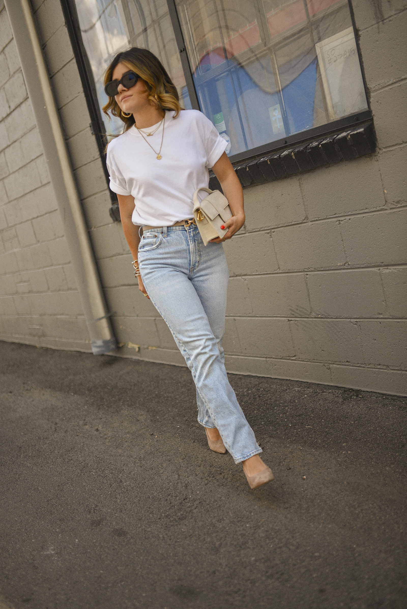 Carolina Hellal of Chic Talk wearing a white tee and straight leg jeans via Abercrombie, Celine sunglasses, Jacquemus , Sam Edelman suede pumps and Miranda Frye gold jewelry. 