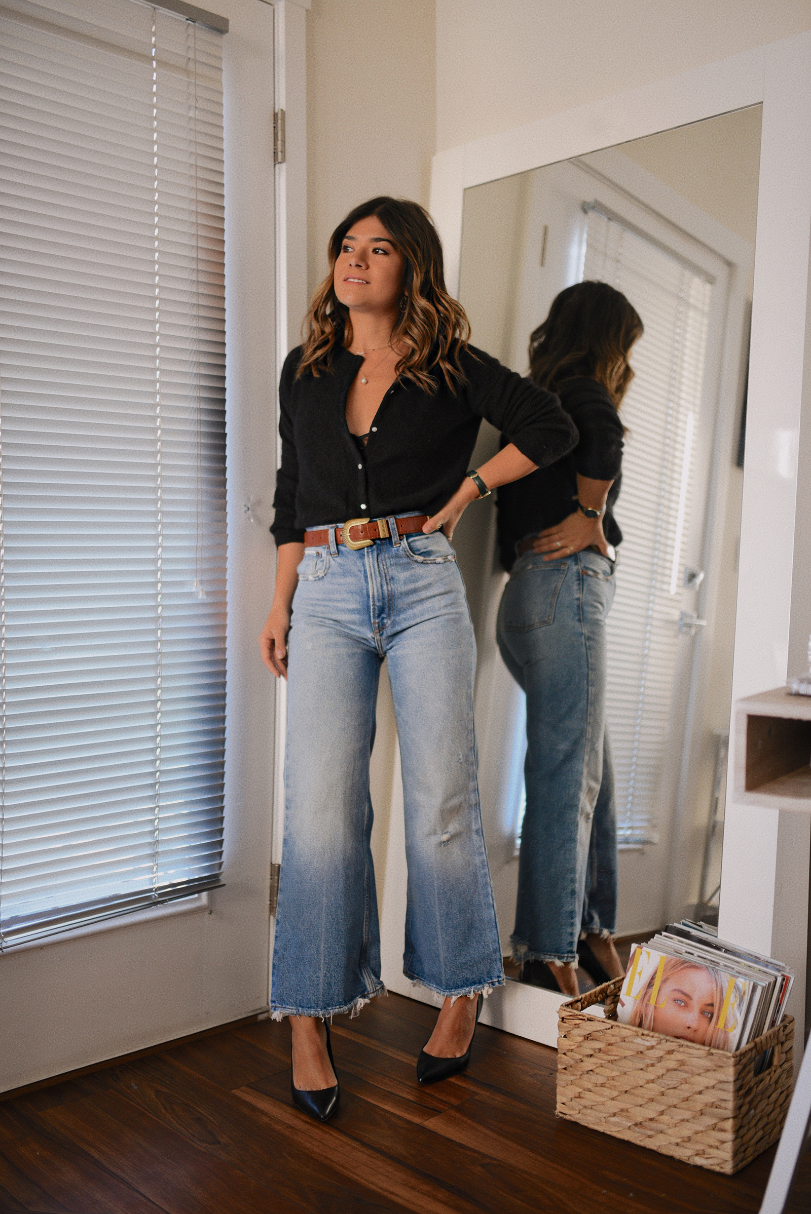 CAROLINA HELLAL FROM CHIC TALK WEARING A BLACK SHIRT, WIDE LEG JEANS AND LEATHER PUMPS