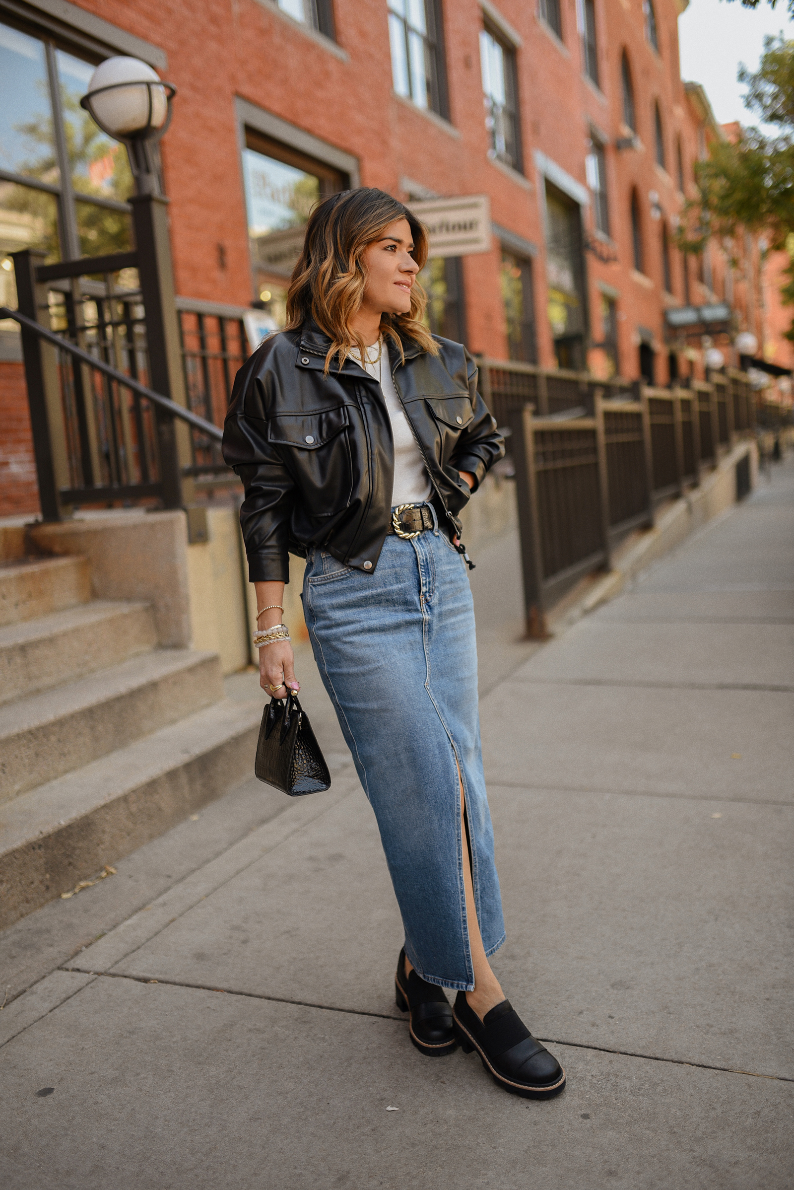 CAROLINA HELLAL FROM CHIC TALK WEARING A HUDSON DENIM MAXI SKIRT, LEATHER BOMBER JACKET AND SOREL JOAN LOAFERS. 