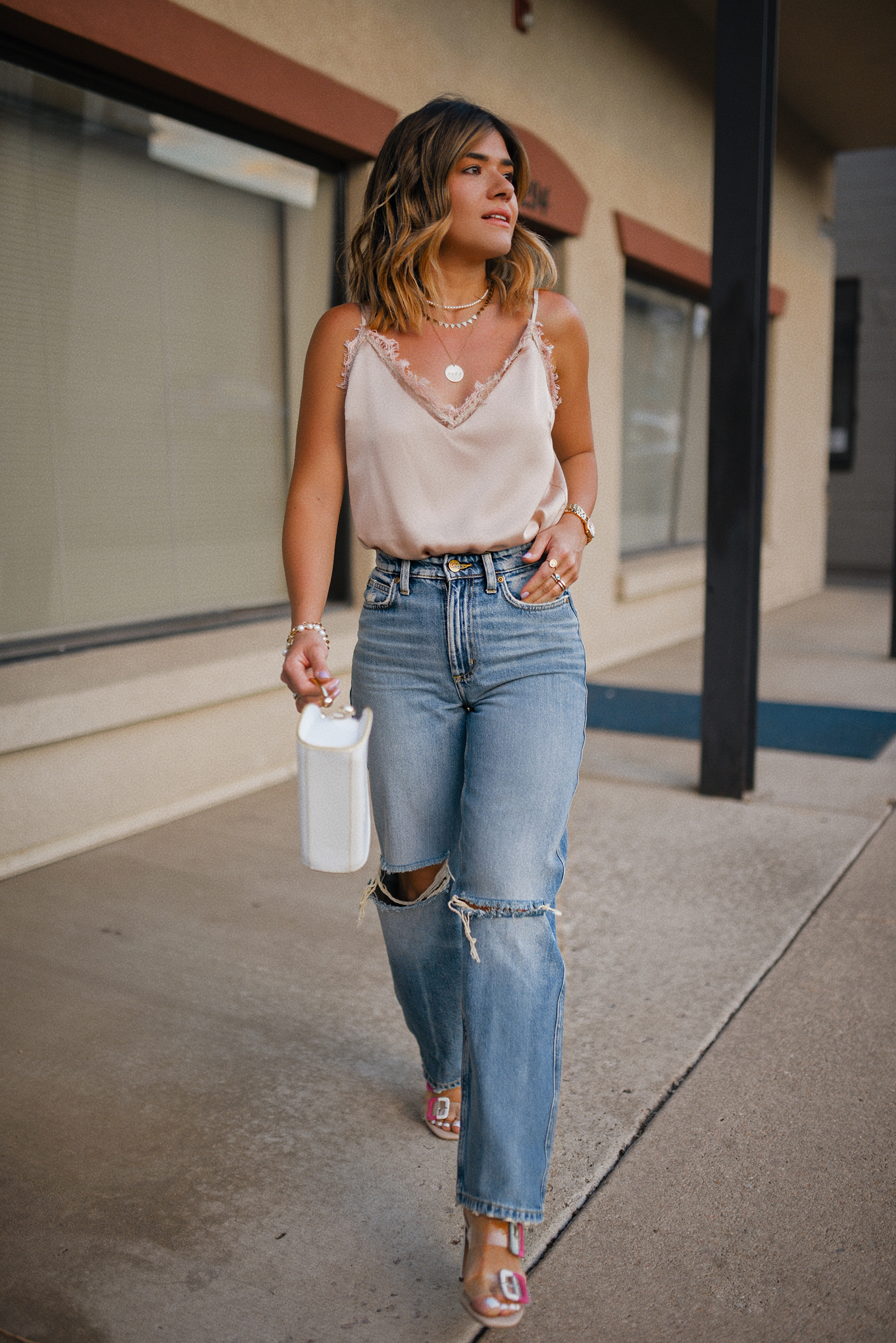 CAROLINA HELLAL FROM CHIC TALK WEARING A PINK CAMISOLE AND STRAIGHT RIPPED JEANS