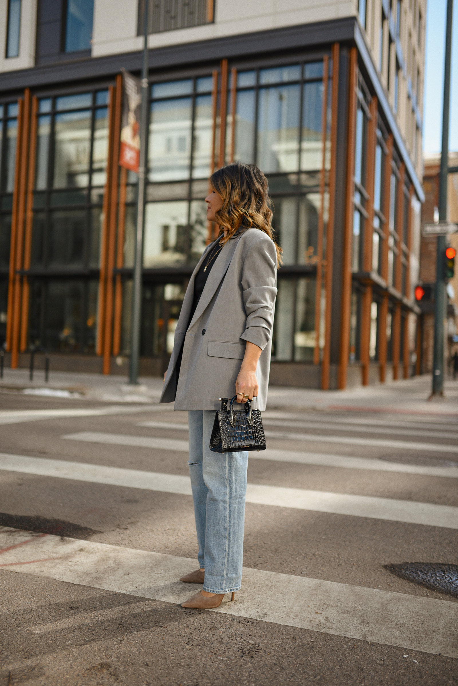 Carolina Hellal of CHIC TALK wearing a Hudson loose jeans and top, a Zara grey blazer, a Strathberry bag and black pumps