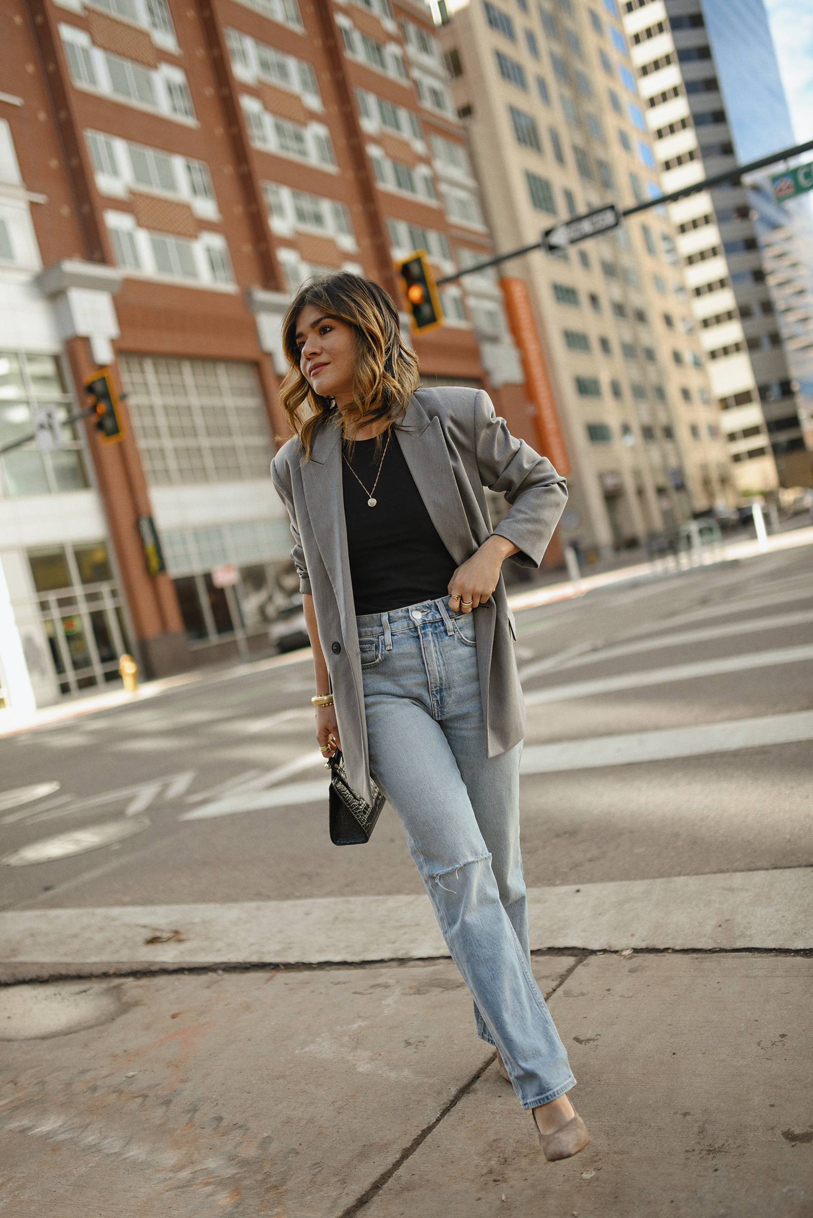 Carolina Hellal of CHIC TALK wearing a Hudson loose jeans and top, a Zara grey blazer, a Strathberry bag and black pumps