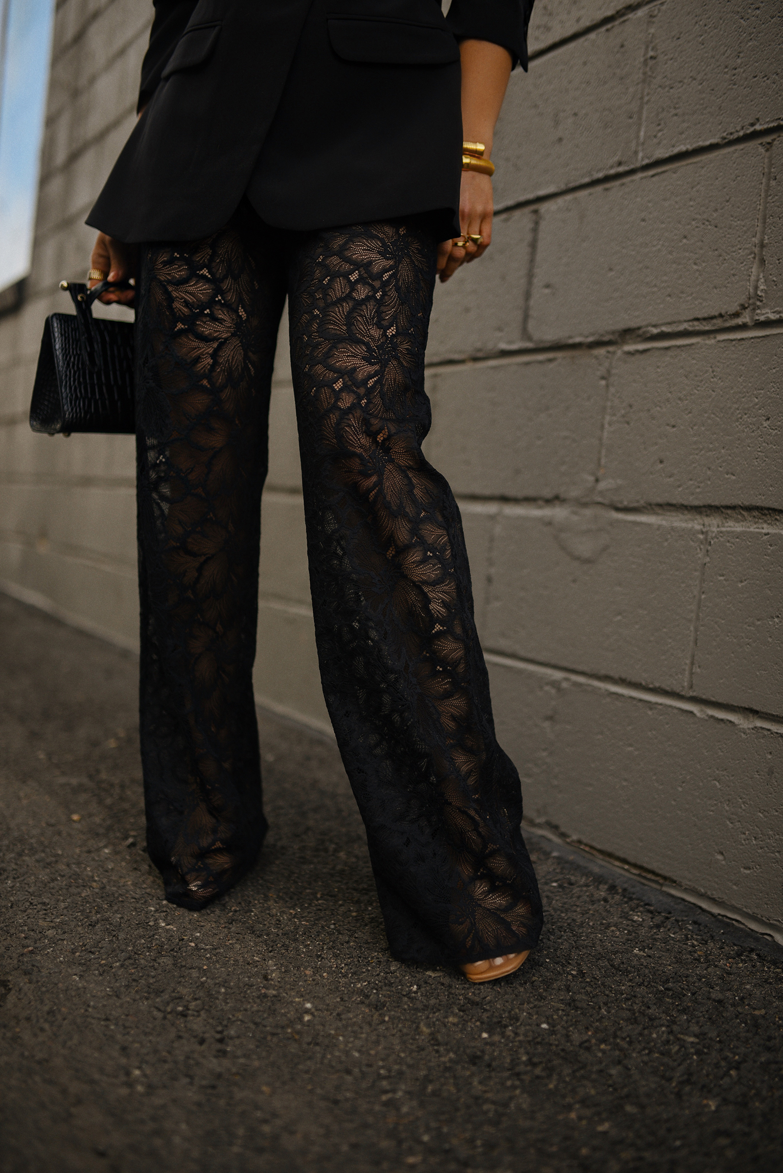 Carolina Hellal of Chic Talk wearing a lace pants via Sezane, a black blazer, a Strathberry leather tote and Amazon belt 
