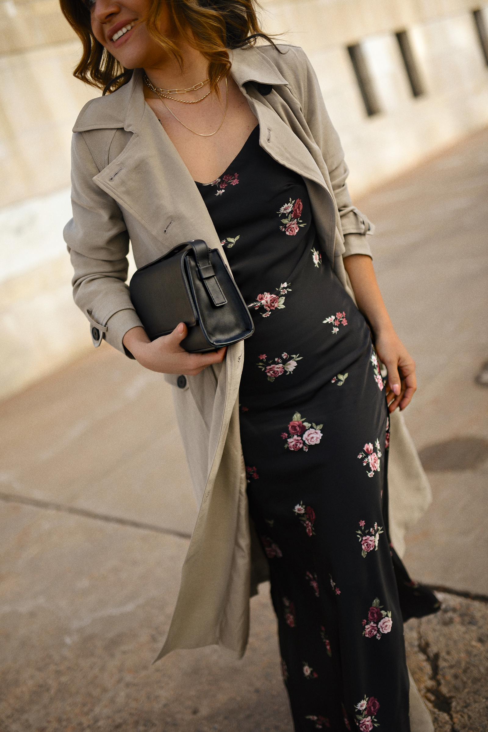Carolina Hellal of Chic Talk wearing a midi floral dress, a trench coat, a cowboy boots and a necklace, everything via Kohls!