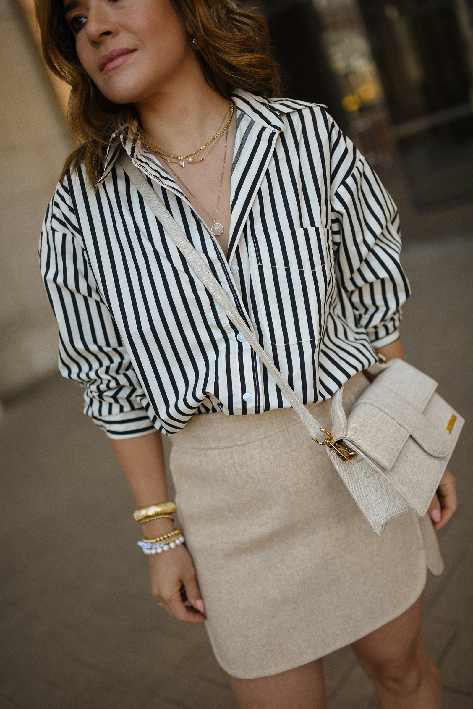 Carolina Hellal of Chic Talk wearing a Sezane mini skirt, H&M striped shirt and Jacquemus bag
