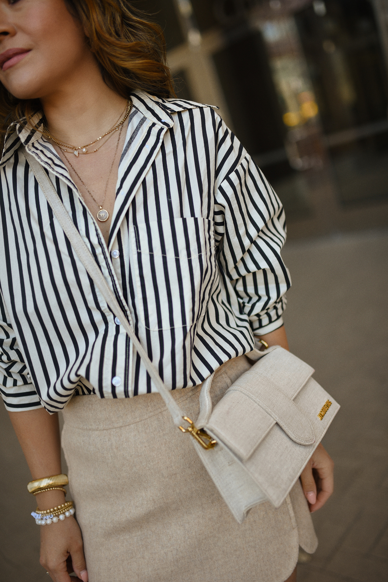 Carolina Hellal of Chic Talk wearing a Sezane mini skirt, H&M striped shirt and Jacquemus bag