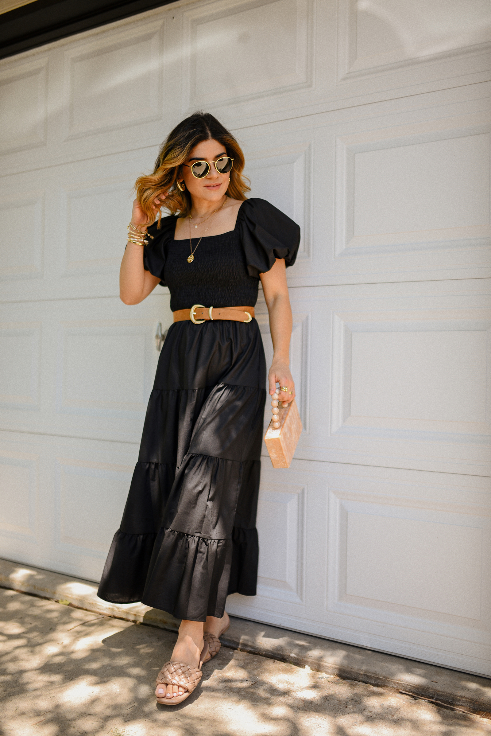 Carolina Hellal of Chic Talk wearing a blak maxi dress via Amazon, braided brown sandals, box hand bag and Ray-Ban sunglasses