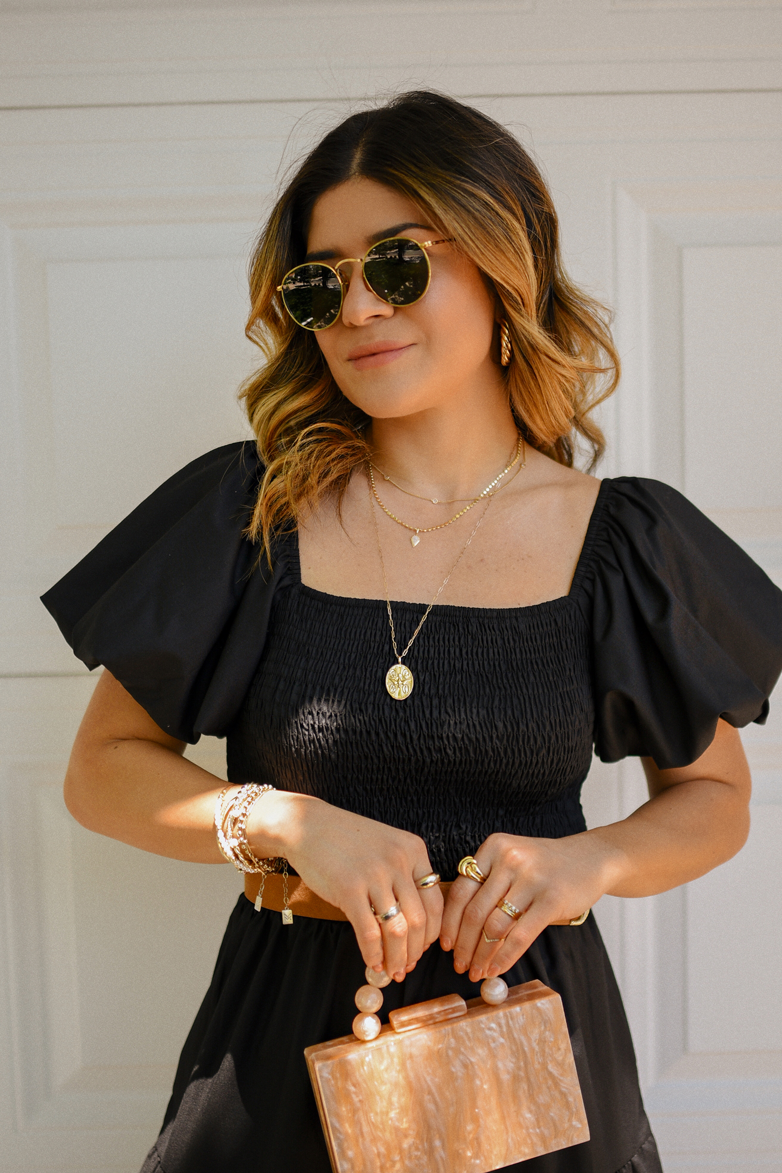 Carolina Hellal of Chic Talk wearing a blak maxi dress via Amazon, braided brown sandals, box hand bag and Ray-Ban sunglasses